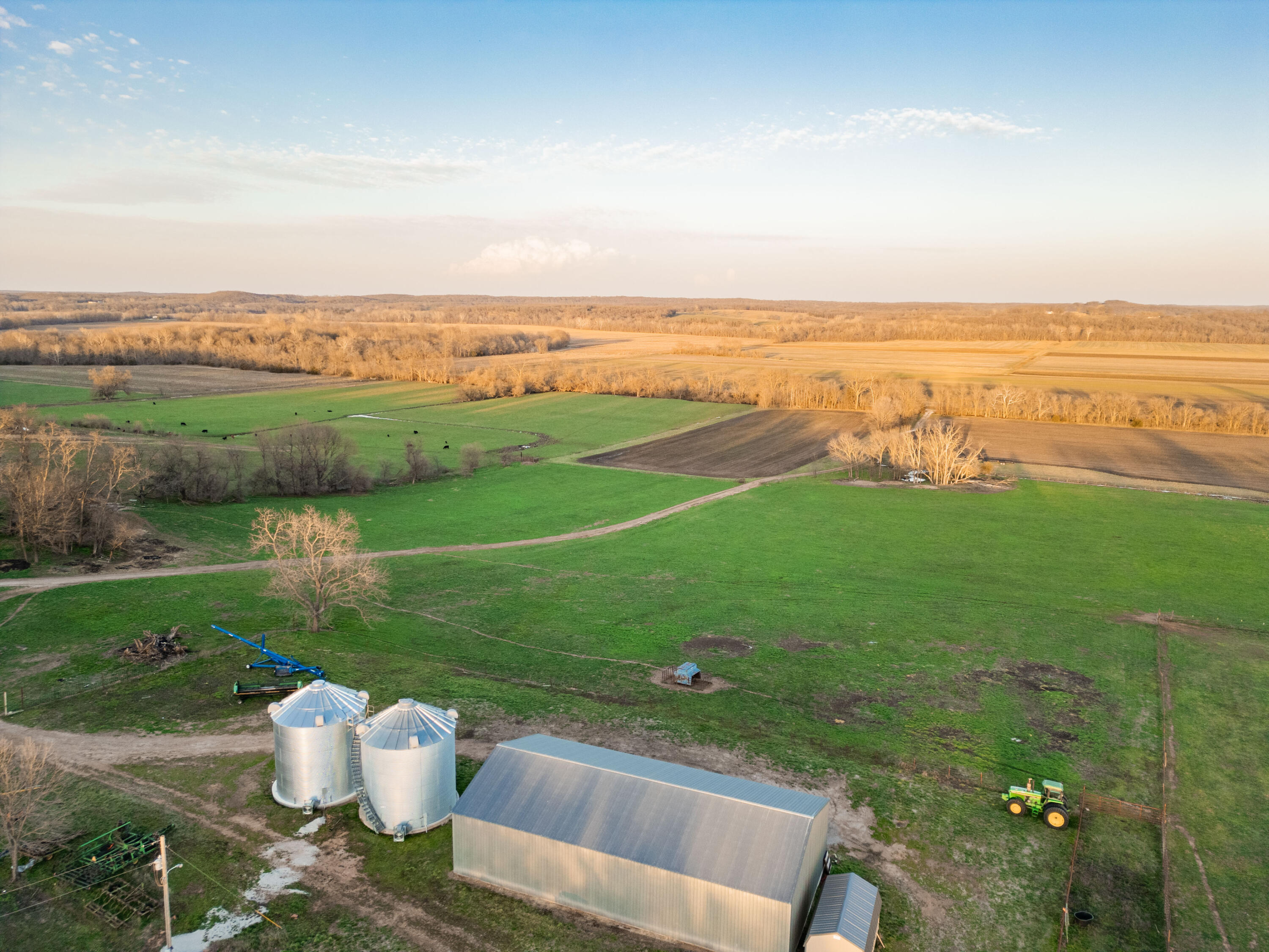 The example of agricultural excellence with this nearly 560-acre farm located in Southwest Missouri. Featuring the highest producing soil profile in Cedar County, this property encompasses over 400 acres of prime tillable soil along the Sac River bottom. The remaining upland acres are fenced and cross-fenced for cattle grazing, and also include the essentials such as grain bins, machine sheds, and cattle working facilities. This farm is a masterpiece, with its perfect placement highlighted by the lay of the land and the water's edge along the eastern boundary.