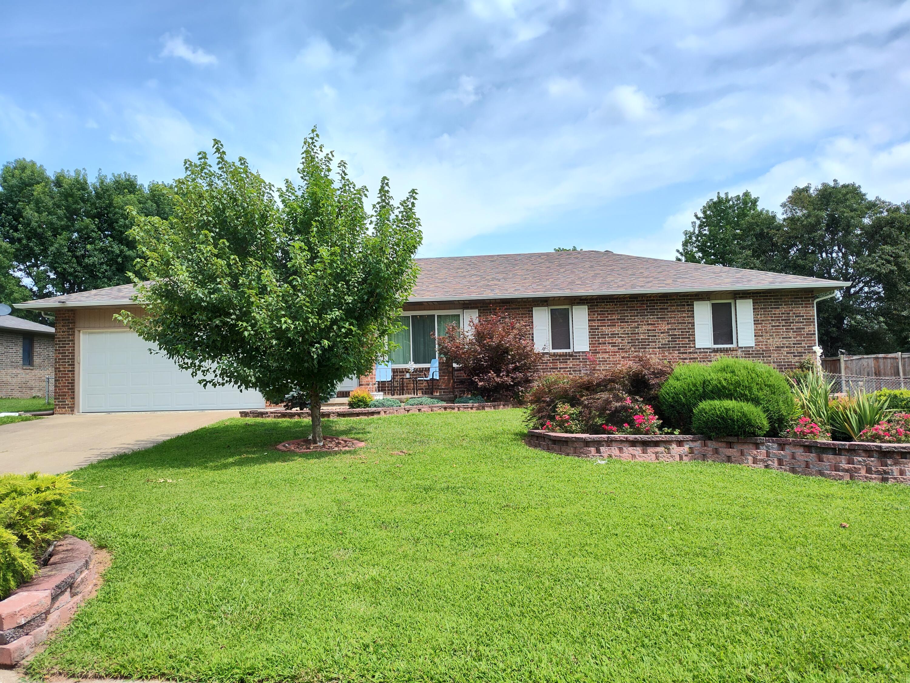 ALL BRICK - BEAUTIFUL LANDSCAPING!  3 bedroom, 2 bath, 2 car garage home looking for new owners!  Large living-dining combo with a tray ceiling.  The kitchen comes with  all appliances. lots of counter space, and breakfast bar.  The primary bedroom has an ensuite bath with a walkin shower.  The laundry room has a wall of storage cabinets, and the washer & dryer will stay.  French doors lead to a covered back porch for your outdoor enjoyment.  The fenced back yard is large, beautifully landscaped, and has a nice storage shed.