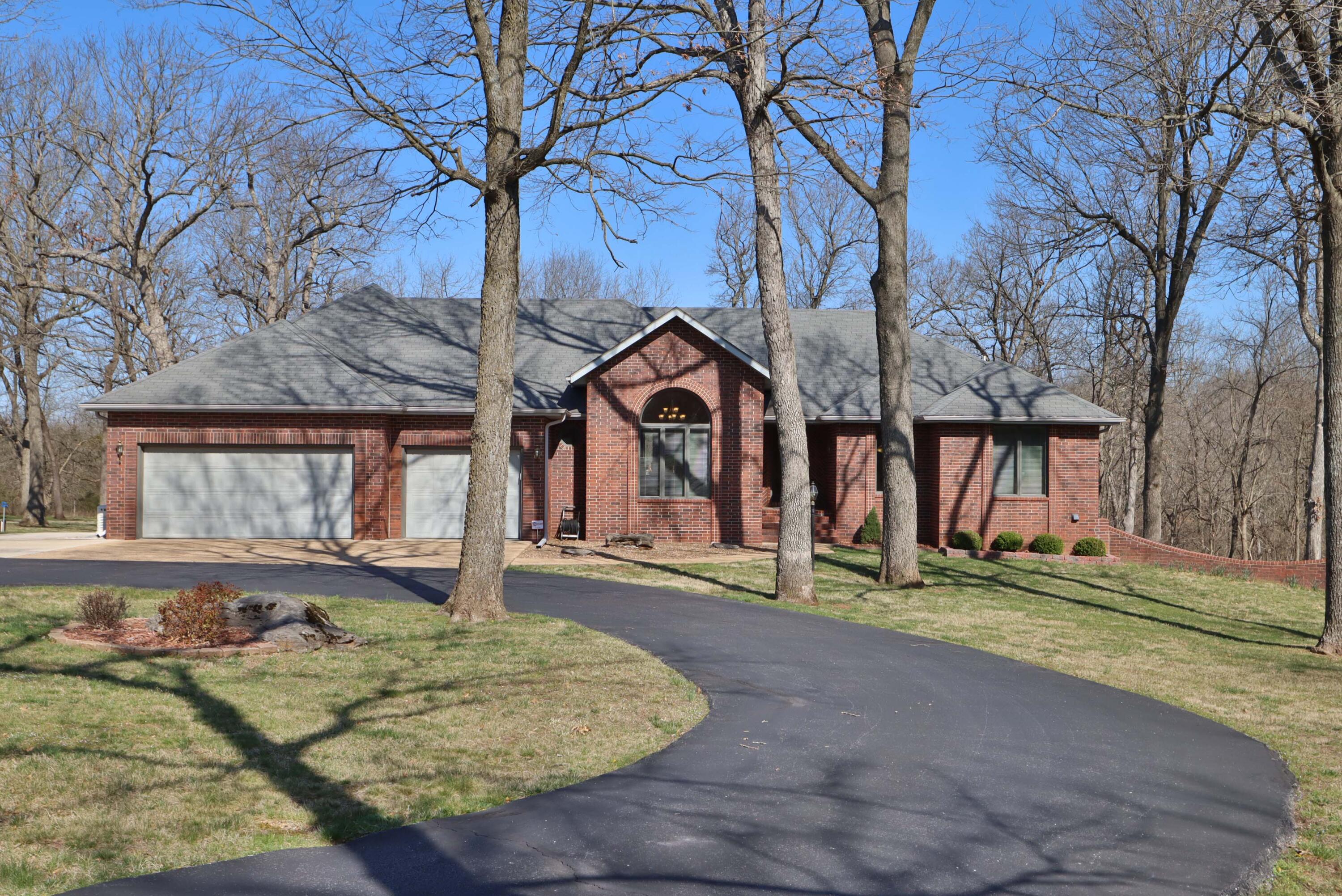 Peace & tranquility await just a few minutes drive from Springfield! Watch the deer & turkey from your screened in porch!  This beautiful all-brick home on 5 acres has everything your heart desires. Bring your RV & park it on the pad with 50 amp service.  In addition to that, there's plenty of room for all your other vehicles in your oversized 3-car garage! Inside, enjoy your large, updated kitchen with tons of cabinets & counter space, walk-out basement, FIVE bedrooms, THREE bathrooms and over 4,000 square feet!  You can move right in & start enjoying the life you've been dreaming of.  Don't miss the Brazilian Cherry hardwood floors, TWO pantries, TWO fireplaces (main level gas, downstairs is wood burning) formal & informal dining areas, spacious bedrooms with lots of natural light from windows.  Outside the walk-out basement there is a large, covered patio & a fenced, gravel dog run for your pups. The primary bedroom & 2 additional bedrooms are on the main level.  The walk-out features, 2 additional bedrooms, John Deere room, & a large family room with wet bar, & space for playing pool, watching movies or cozying up to the fireplace with the walk-out leading to the patio to enjoy more of your beautiful private backyard. A whole house generator, alarm, water treatment system and added attic insulation help keep the home secure and comfortable year around. The home sits at the end of a secluded lane in a quiet neighborhood of mature trees & over-sized lots.  You must see to appreciate the beauty!  Schedule your private viewing today - it could change your life!