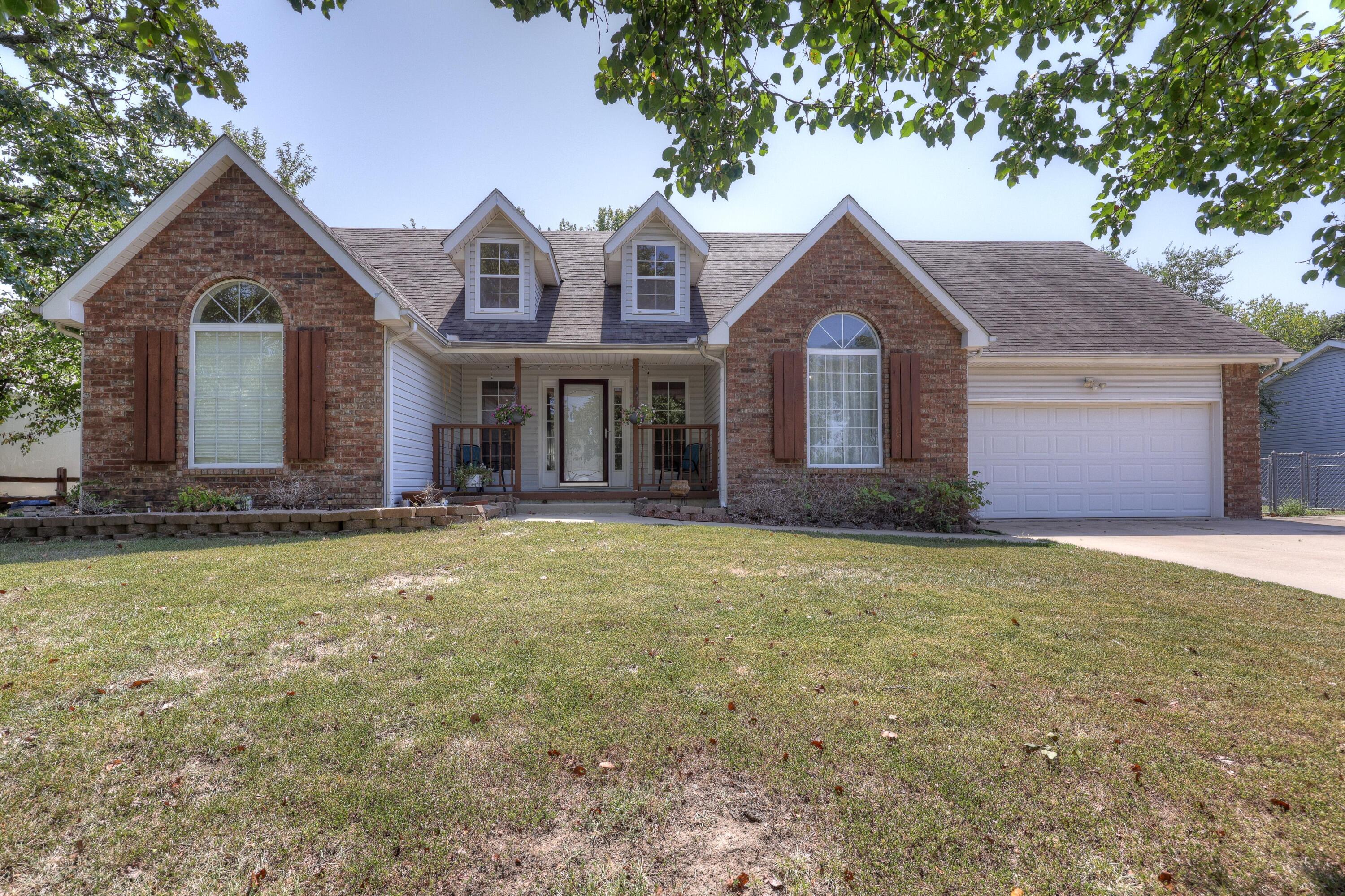 Welcome home! This beautiful 4 bedroom, 2 bathroom home sits on a gorgeous shaded lot right outside of the city limits. Joplin address and Carl Junction schools. Once you step inside you will be met with soaring ceilings and an open floor plan. The kitchen is open to the living room and features a gas range, plenty of storage and a very functional layout. Don't forget about the heated/cooled sunroom off of the kitchen. Spacious main level master bedroom with attached ensuite with jetted tub, new flooring and large closet. New carpet for master bedroom to be installed 10/21. You will find 2 additional bedrooms downstairs each with large closets. So much storage in this home! Step up the private stairs to the large 4th bedroom (non-conforming due to no closet). This room would also be perfect for a home gym, office or media room. Attic space is easily accessible and provides even more storage options. Brand new hot water heater! Outside features a spectacular shaded lot with 3 storage sheds, 10-person storm shelter, carport, playset and several raised bed gardens.  A garden lover's dream! Schedule your showing today!