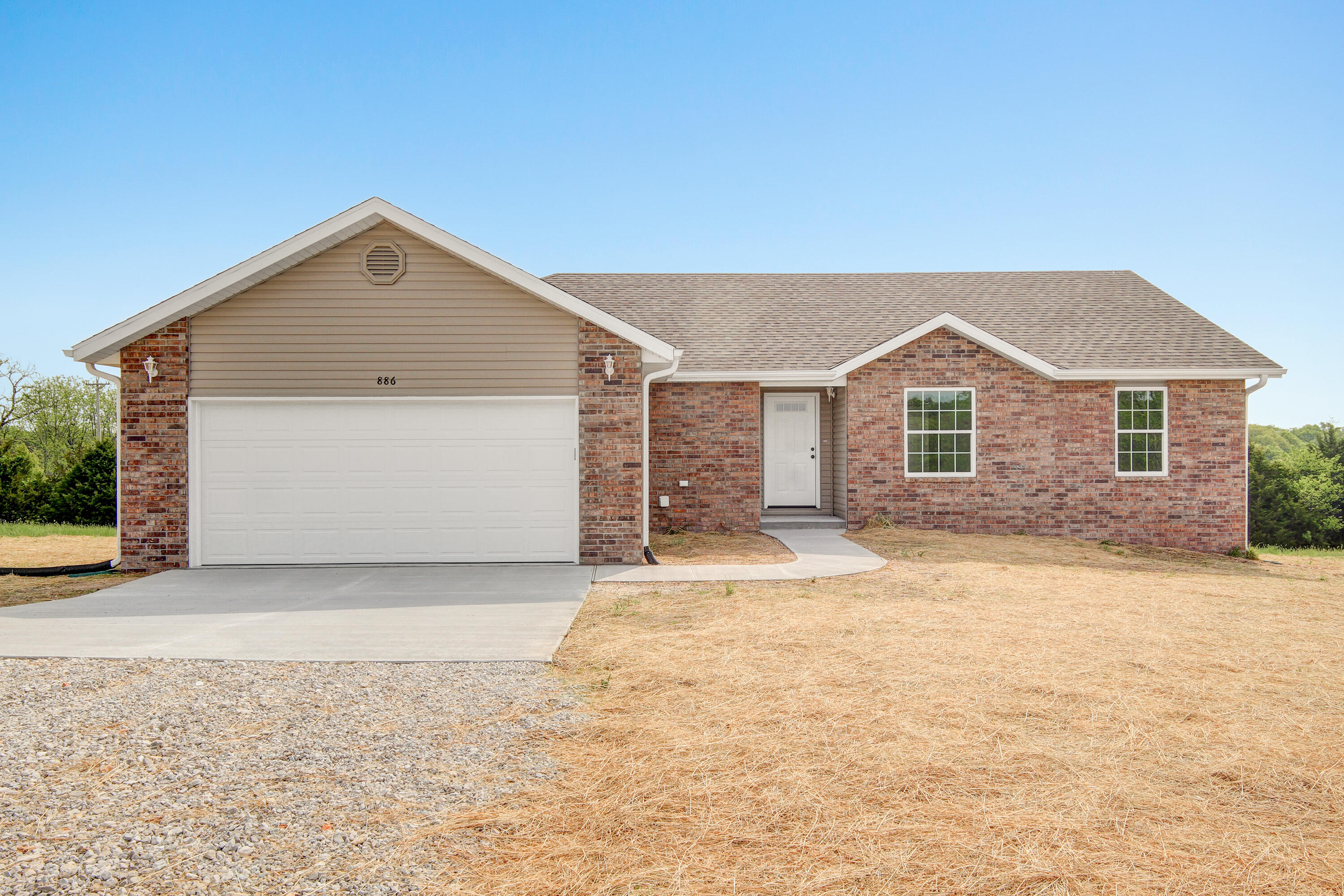 Fantastic 2022 New Build with great views on 4+ acres and easy access to 65 Hwy!  Tract 2 has a great location for a future shop with electric close.   The exterior offers brick front, covered porch, nice deck, level area, gentle slope, and some trees with a sense of privacy.  Inside shows great....offering a split floorplan, vinyl plank flooring, carpet in bedrooms, textured ceilings, gas fireplace in living room, and open feel.  The kitchen offers granite countertops, new black/stainless appliances, stainless sink, white cabinets, good sized dining area, and easy access to the deck.  The master hosts carpet in the bedroom, walk-in tiled shower, walk-in closet, raised vanity, and privacy.  This home is a Must See!