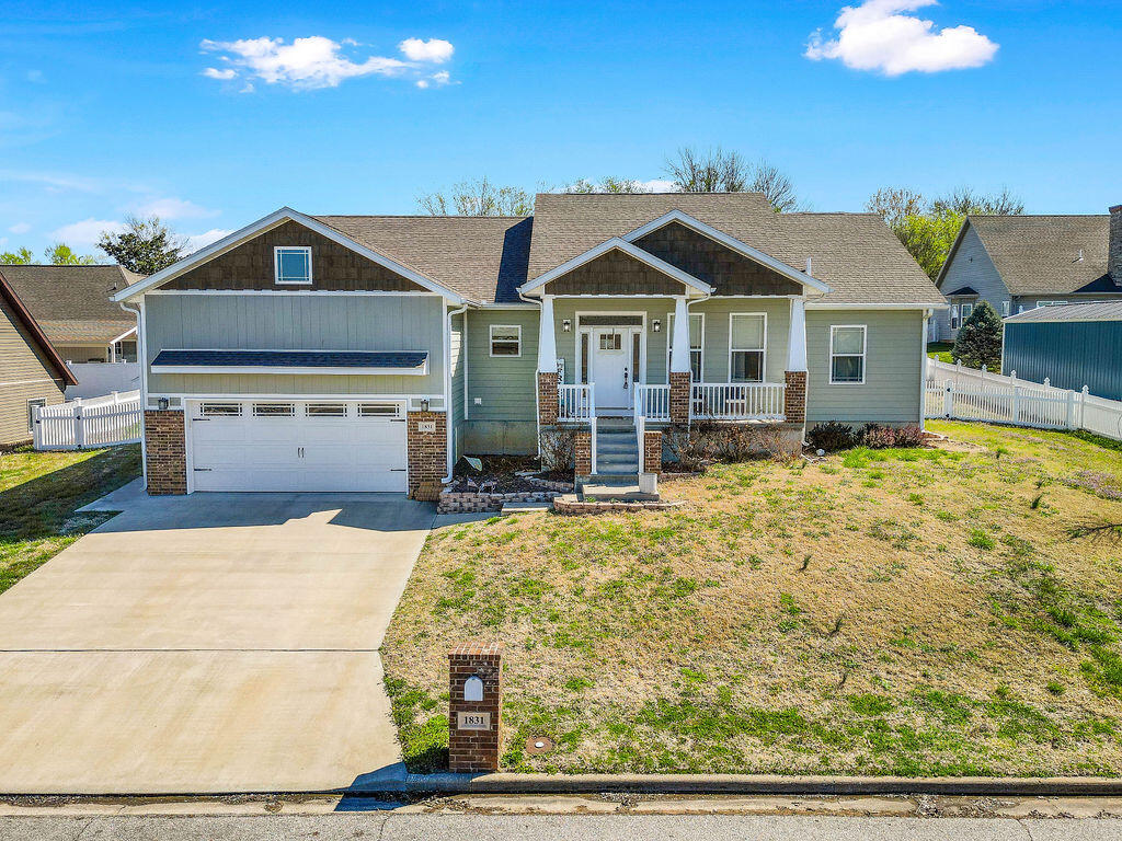Beautiful custom 3 Bed/3 Bath home in quiet 'Cattails' neighborhood. Split bedroom plan with open spacious living area. Large  kitchen with  stainless built in Oven, microwave, and dishwasher. Solid surface tops and tiled backsplashes. Eat at bar with dark stained cabinetry. Engineered hardwood and tile flooring throughout with spacious closets and lots of storage. Master en suite with walkin closet and double sinks. All of the above is just upstairs, also includes full basement for total of over 3700 ft of living space. Basement is mostly finished with stained concrete floors, a full bath, and built in storage. Low maintenance vinyl exterior with brick accents and sloped, landscaped yard on a spacious 100x105 ft lot. 'Community Only' pool membership available. Rounded out with a 2 car garage and a vinyl fenced back yard. This  well taken care of home is ready for your family! Call an agent for a tour of this great home.