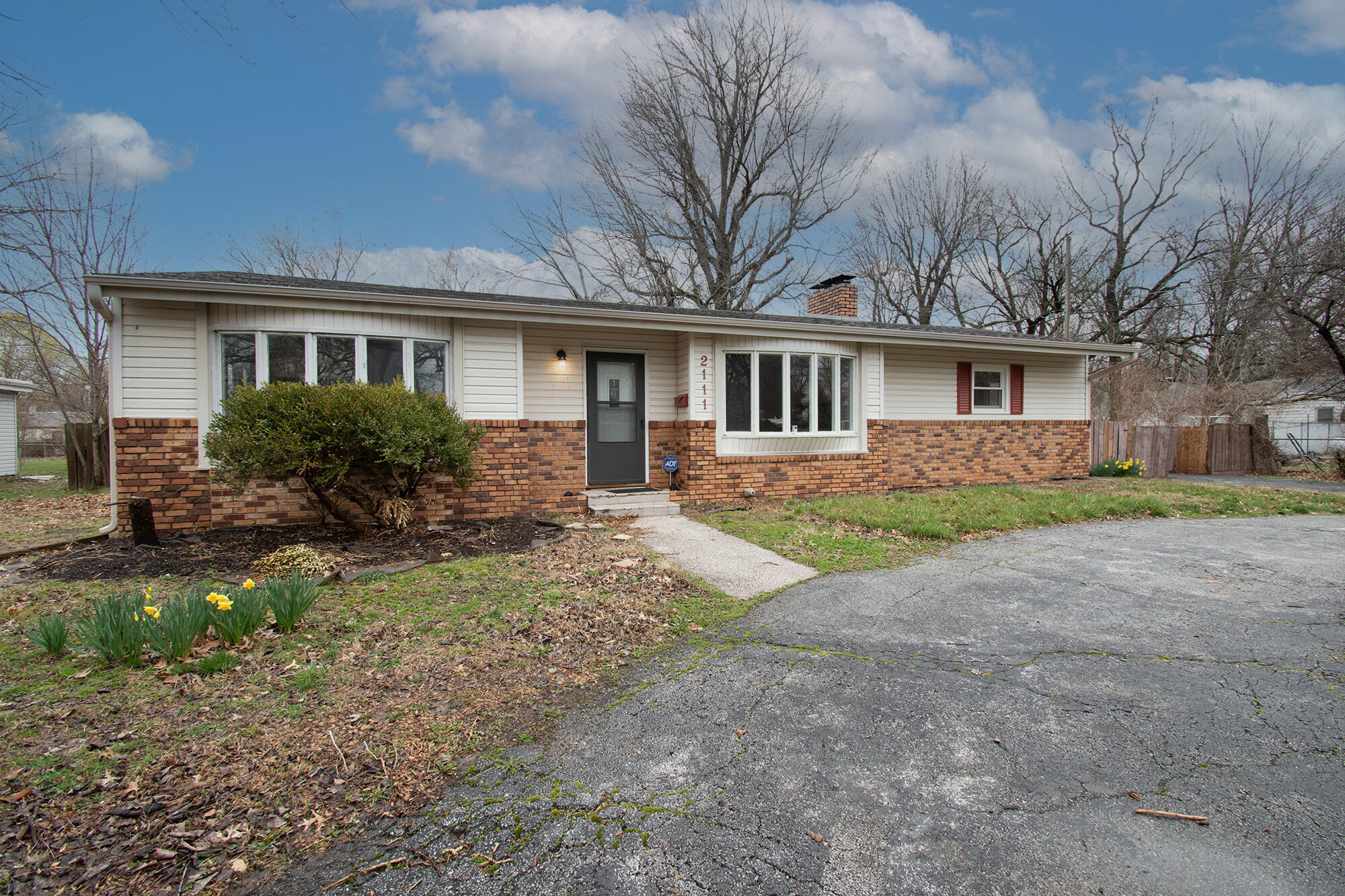 Hard to find four bedroom home with two full baths, or three bedrooms with two large living areas! Hardwood floors throughout most of the home, wood-burning fireplace, large laundry/mudroom. Refrigerator stays! Newer roof and windows, nice deck overlooking large fenced lot. Circle drive provides ample off-street parking with additional parking pad through fence gate. Call to see today!