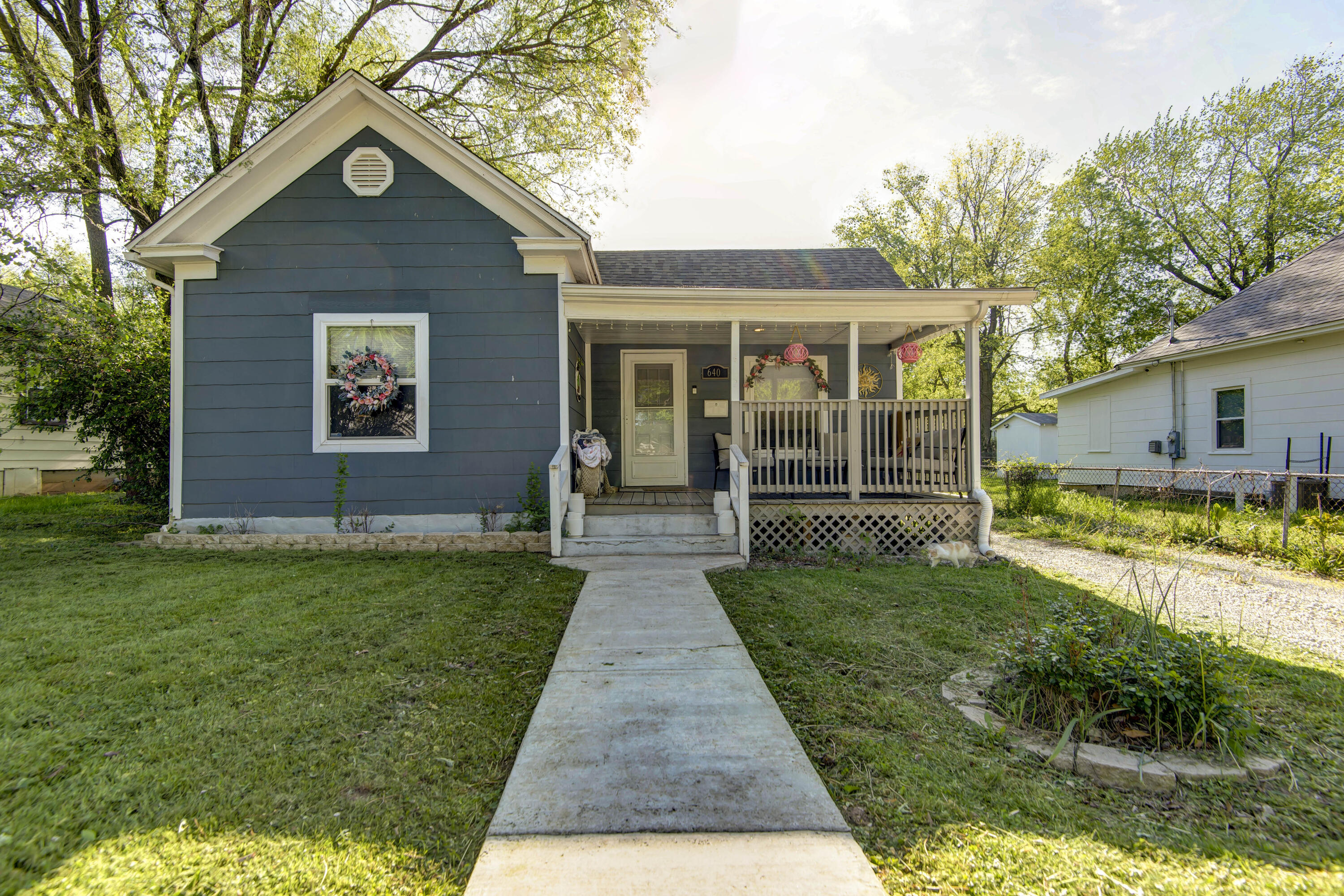 ADORABLE!.  This darling bungalow is a great starter home.  This home has a newer roof, lights fixtures and new windows.  New hot water tank and newer flooring. Nice bathroom with tile shower walls.  Huge out building attached to a car port.  Tornado shelter (as is) in the very large backyard.  This home will not last long.