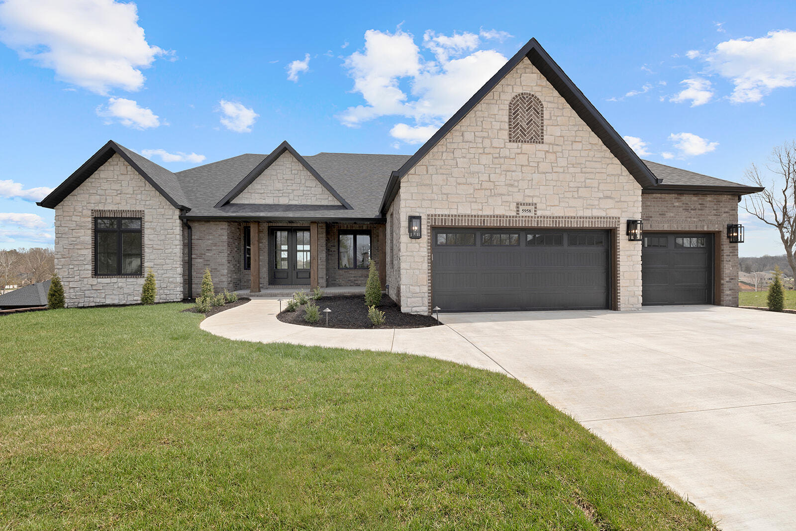 Eckenrode built. Stunning new construction built with supreme quality in Anthony Park, Springfield's premier south side new development. This home features a wonderful open concept design with soaring ceilings and large windows to maximize natural light. As you enter through the double doors you will notice the fantastic engineered hardwood flooring throughout the main level leading into the main dining area adjacent to the kitchen. Large great room with stone fireplace, trey ceilings and built in cabinetry. Huge kitchen island with seating for 4, commercial grade appliances, main sink with window and prep sink, vent hood over range. Large butlers pantry is also adjacent to the kitchen with ample storage and custom cabinetry. Large primary bedroom suite with hardwood throughout, access to back deck from primary suite. Primary bathroom features huge walk in shower with soaking tub, contemporary vanity, separate toilet room and storage closet. Huge closet with custom shelving leads into the laundry room and mudroom area off of the 3 car garage. Half bath in hallway across from mudroom. Two more bedrooms on main level with large bath with double vanities, quartz countertops, and custom cabinetry. Heading downstairs you will notice the gorgeous wood encased staircase. Expansive second living space with stone fireplace and large kitchen area with bar. Wonderful rec room space off of the basement living area, could be a theater room. John Deere room off of rec room features epoxy flooring and double doors to exterior. Two more bedrooms on basement level with full bath, storage, and storm shelter area. Outside you will find large covered front and back porches, landscape lighting, and a fully sodded yard. This home has been built with precision and care, move in ready for quick closing.