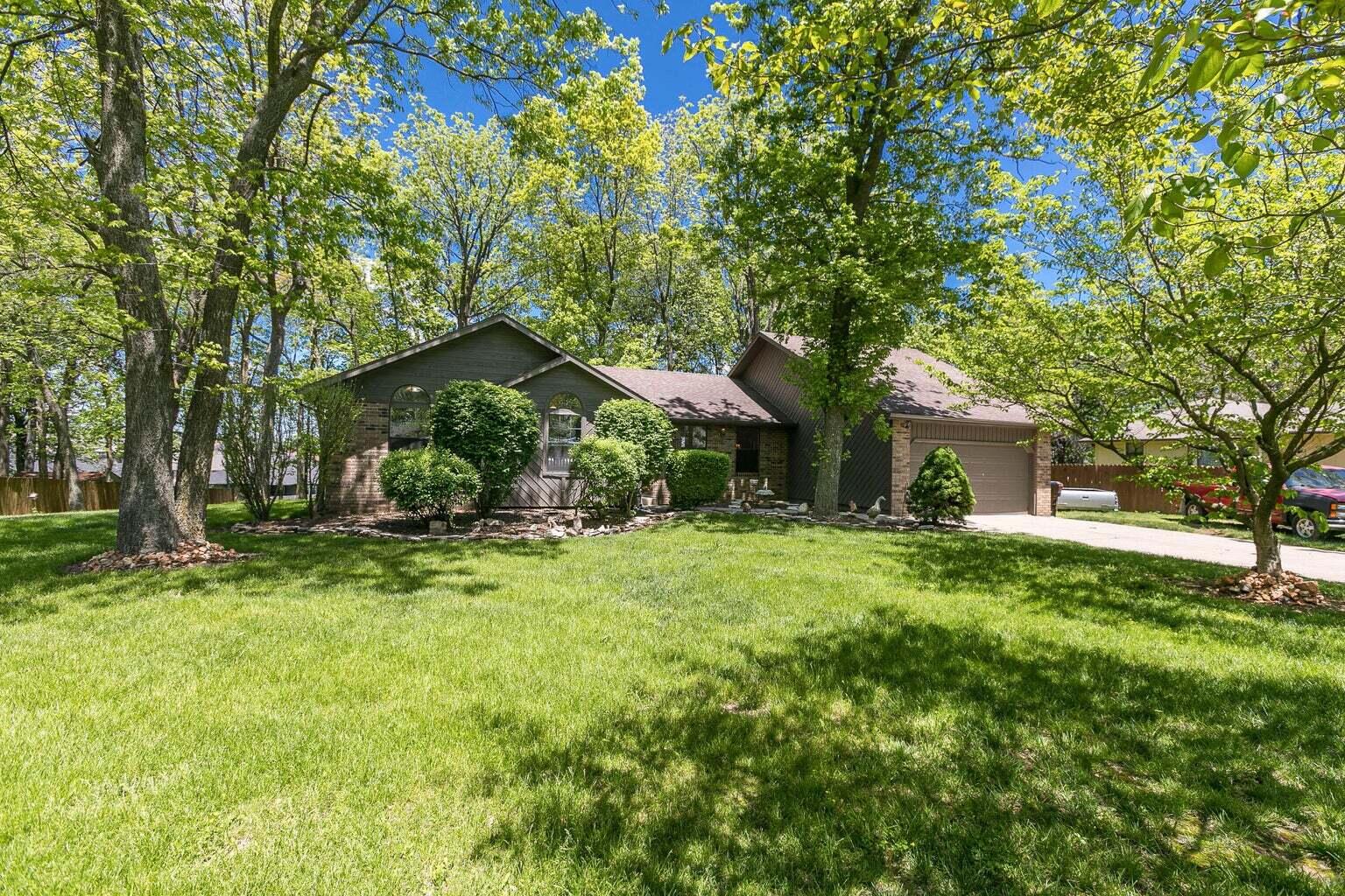 Tucked away in the trees on 3/4 AC and boasting large spaces throughout. An absolutely Huge living room with brick wood burning fireplace and vaulted ceilings welcomes you. The Large dining room is separated from the kitchen by a breakfast bar. Lots of cabinets and counter space plus pantry and walk-through laundry. Large master suite with private rear deck access, big closet, double sinks and walk-in shower. 2 more bedrooms with another full bathroom + a bonus room that would make for great home office, play room or library. You will fall in Love with this .74 AC yard; Dotted with mature trees, it's level and inviting while giving that extra room to stretch and do hobbies. Quality construction with wood cabinets and trim, solid core hardwood doors. Brand new roof in 2022?