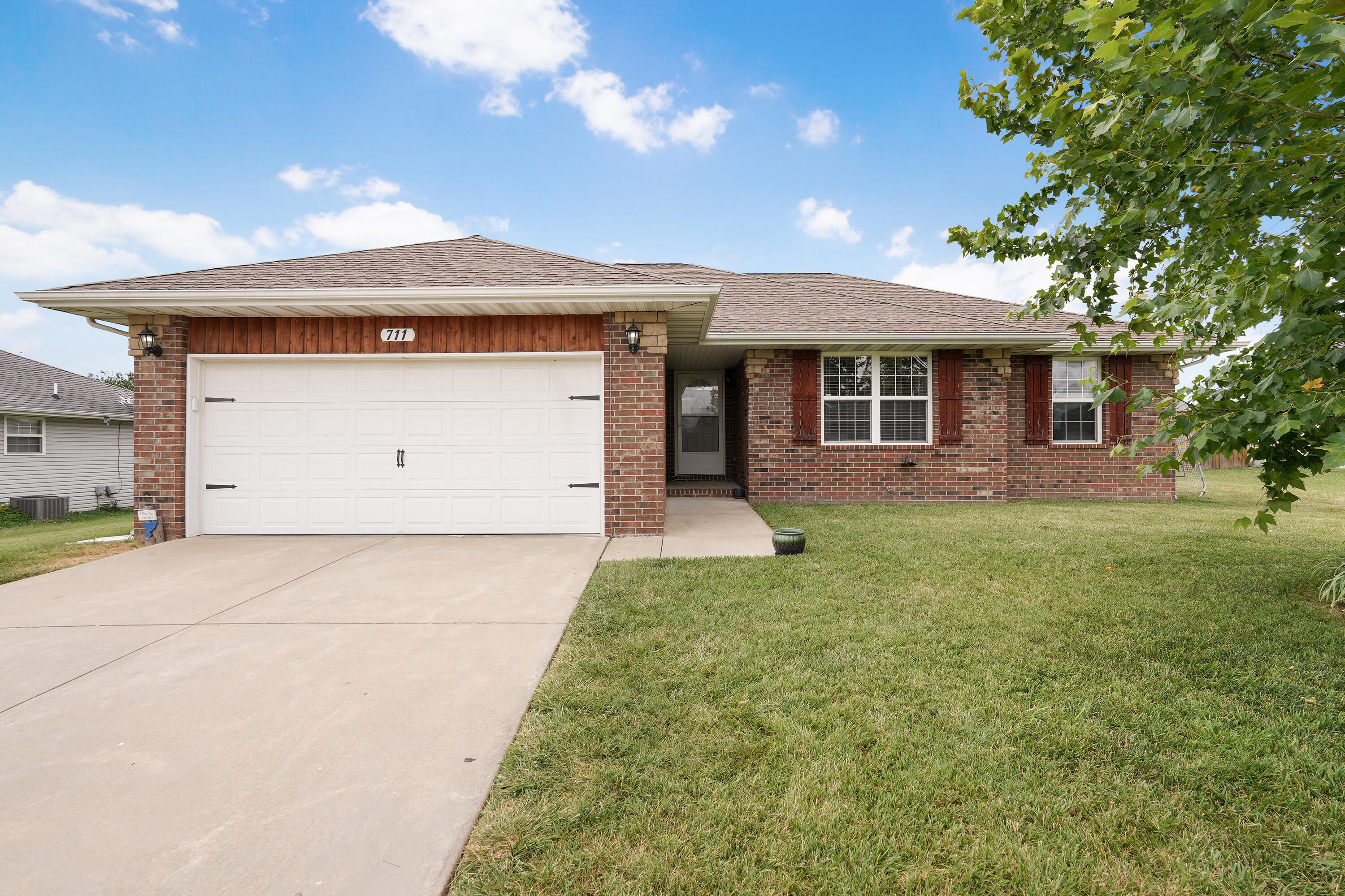 711 W. Lake Ave. Clever, MO 65631. MOVE-IN READY beautiful home within walking distance to Clever Elementary! This lovely home features 3 bedrooms, 2 full bathrooms, and is over 1,300 square feet. Fully remodeled with a beautiful white kitchen with gorgeous granite counters, stainless steel appliances, stunning dark luxury laminate wood plank floors throughout (no carpet!) and quartz counters in each bathroom.  In the Winter time enjoy the nice wood burning fireplace in the living room, and cool off on the hot days with the attic fan! The backyard is spacious and fully privacy fenced in, perfect for your fur babies! Plus, there is a nice work bench in the garage for all of your DIY project needs! Don't miss this one!