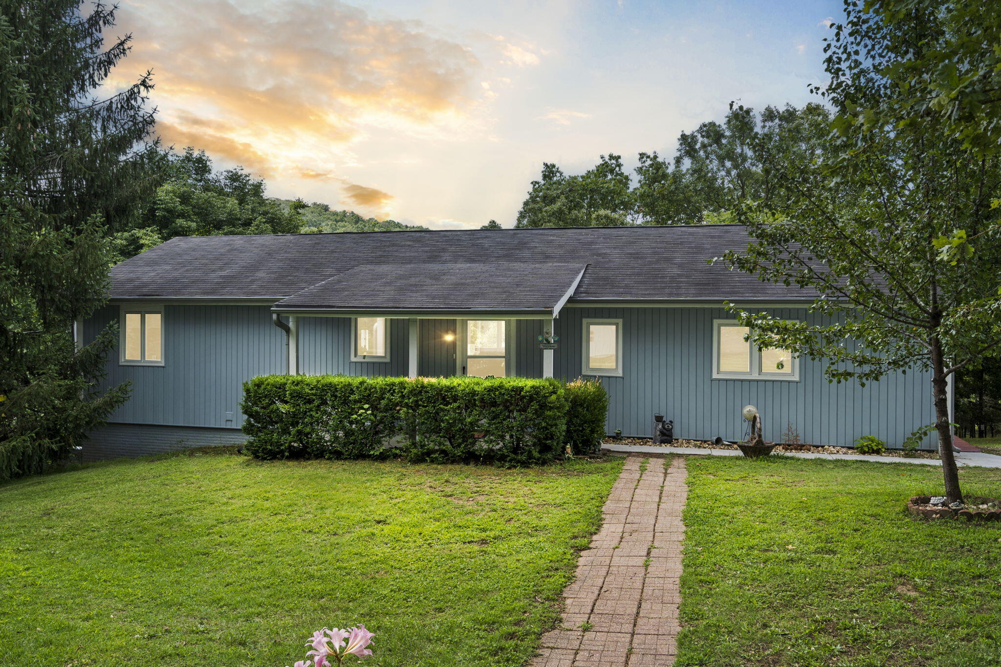 Experience the joy of living lakefront on Table Rock Lake! This delightful three-bedroom, two-bathroom home features a spacious open floor plan that's perfect for gathering with family and friends. Situated on a generous 3/4 acre lot, just 200 feet from the water, this property offers stunning views and peaceful surroundings, complete with a community dock slip available for purchase.The home includes a partially finished basement with a second living area, plus an unfinished room with an epoxy-poured concrete floor and a window A/C unit, making it easy to customize to your liking. Enjoy the peace of mind that comes with the recently installed new polymer siding, backed by a transferable warranty.Relax or entertain on the large covered back deck, which has been recently re-stained for added appeal. The detached, spacious two-car garage provides ample storage and parking space.Meticulously maintained, this home offers comfort and tranquility in a picturesque lakefront setting. Don't miss the opportunity to own this unique property and create lasting memories by the water.