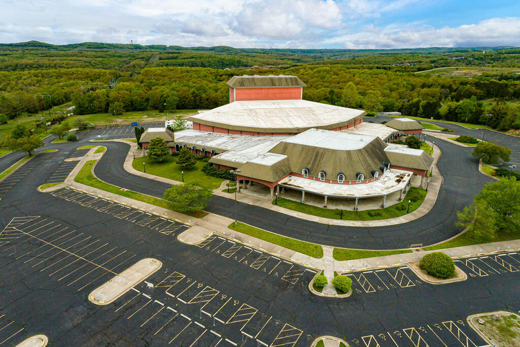 Reduced $300,000 for fast sale!  One of Branson's premier theatres and event centers is offered ''fully furnished''. This property is fully functional with full sound and lights, box office, offices, tech facilities...all ready to have a show or event almost immediately. The 113,000 sq. ft. building sets on nearly 24 acres with further development potential. Spacious wide-open lobby, ample paved parking, possibly the best motor coach un-loading access in town, ADA accessible, with seating capacity of 2634. Property includes a 2 BR apartment with full kitchen and rehearsal hall