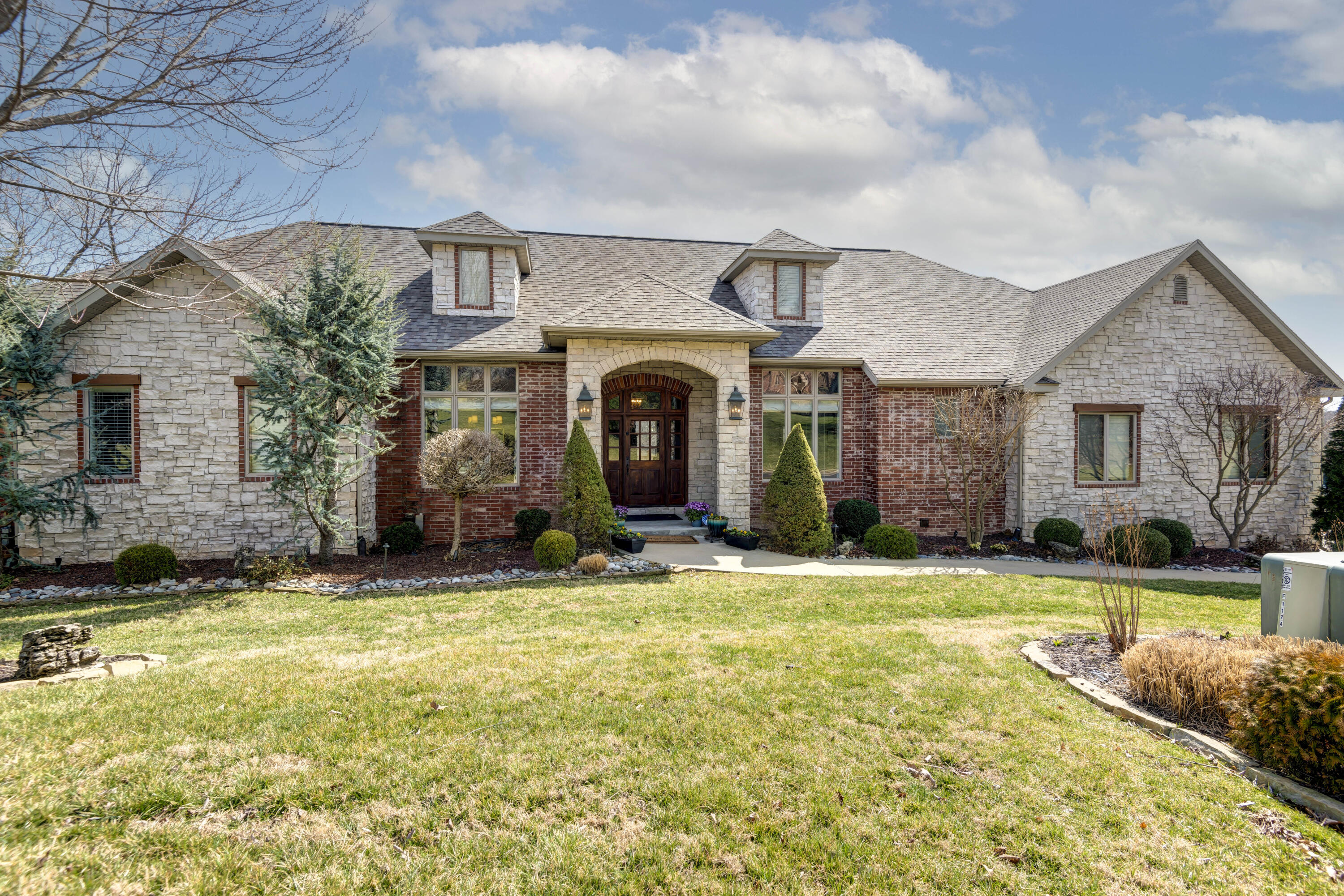 Fantastic home on two lots in Stone Meadow perched above the neighborhood common area. Convenient to pool, trail, tennis courts and recreational fields; this home is in a perfect spot for an active family. Custom-built for the original owner, this property has SO much to offer: A ''cooks' kitchen'' with commercial gas cook top, double ovens, warming drawer, double Sub Zero fridge, enormous walk-in pantry, island, commercial vent, ice maker, vegetable sink, and lots of great storage. Enormous Master suite with gas fireplace, access to the deck, freestanding soaking tub, beautiful tile work, and a dream closet. Home office with French doors, formal dining, both a Living room and Hearth room, plus two more bedrooms on the main level, separated by a Jack-n-Jill bath. The Fun basement has two more bedrooms (w/Jack-n-Jill bath also), Home theatre, enormous exercise room (or play room), fantastic home bar w/fridge, dishwasher, and microwave. large Rec. room, and a family room. Besides everything described, the home also has a ton of storage, two massive decks, Mud room, beamed ceilings, 1.5 year old roof, 4-gas fireplaces, 2-half baths and a water softener,  This is a fantastic property!