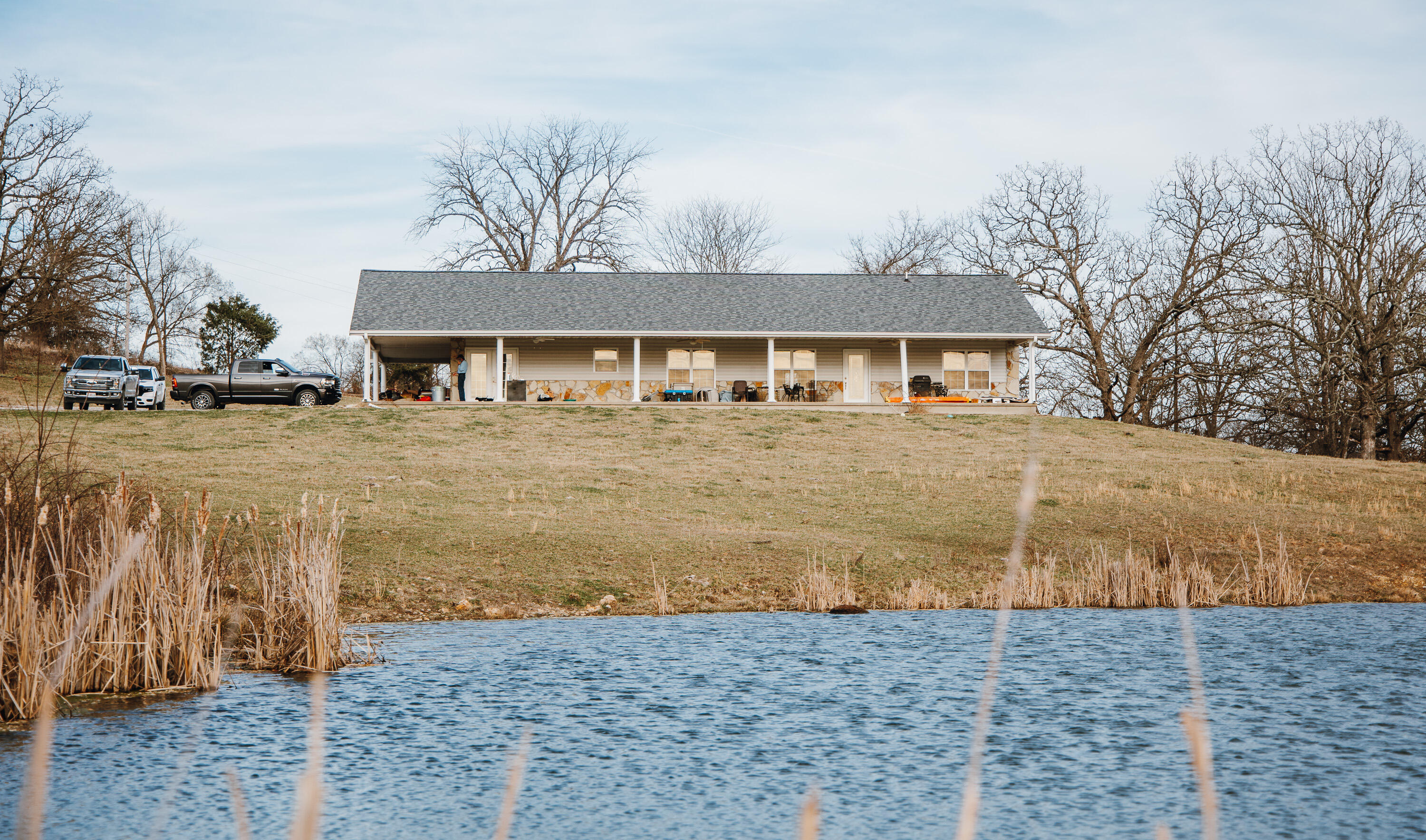 Nestled in Texas County, this 2,200+ sq ft home rests on 155 m/l acres of rolling farmland. Key features include: beautiful stone fireplace, 3 bedrooms, 2 baths, excellent pastures, sturdy fencing, and live water. Mere minutes from the city, it offers a peaceful country lifestyle. The charming home overlooks a spring-fed pond, complemented by rotational grazing pastures and year-round creek pockets. The property has tons of wildlife including whitetail deer and turkey. A gated entrance ensures security and privacy. This property seamlessly blends rural charm with modern comfort, creating an idyllic retreat. Showings must have 24 hour notice prior to showing and must be confirmed through the MLS.