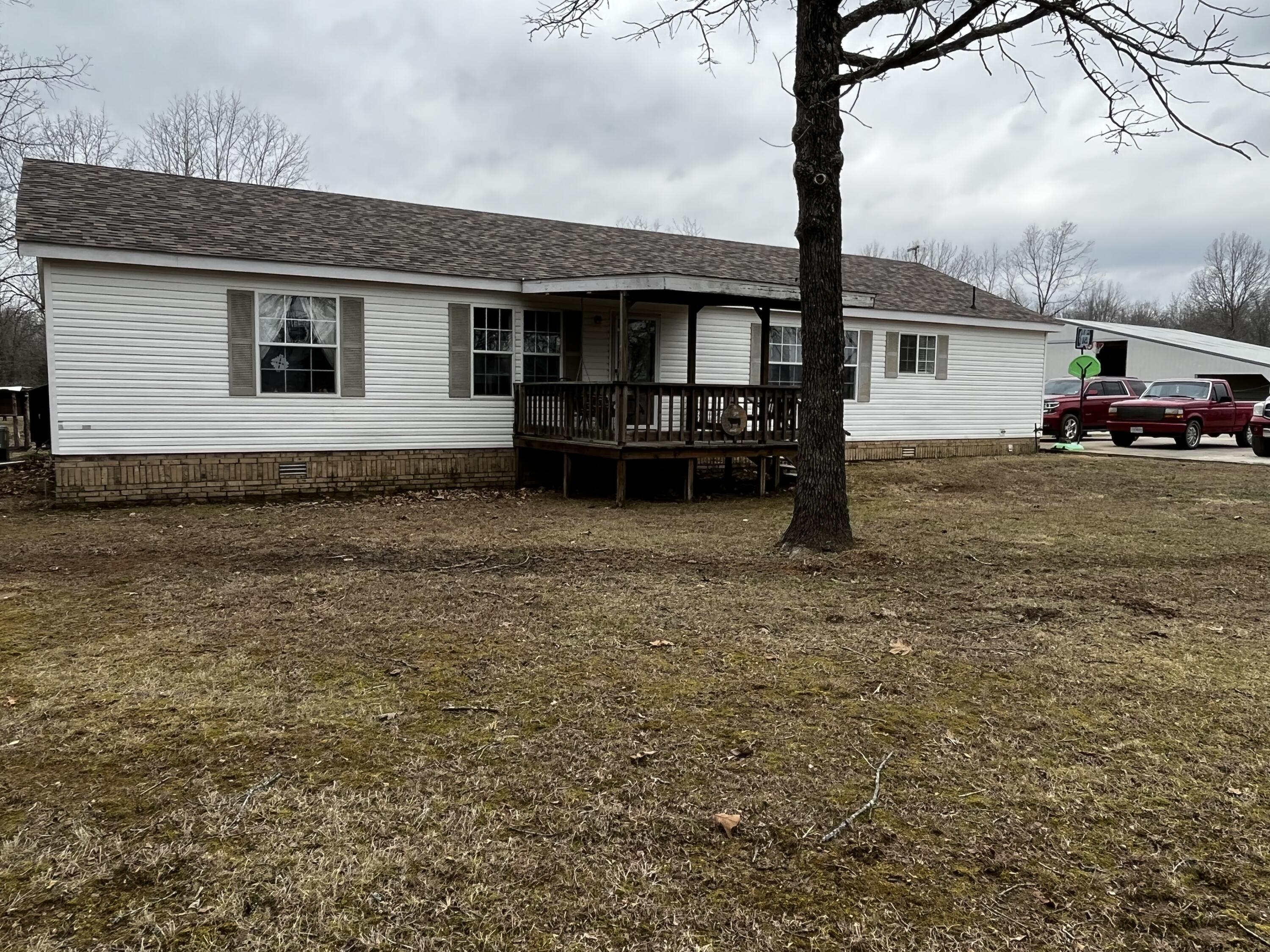 37.6 ACRES OF LEVEL FARM LAND......Check out this beautiful manufactured home on permanent foundation!  Great farmland with plenty of cleared and wooded areas.  Pasture is Perimeter fenced and cross fenced with 1 pond.   3400 sq. ft.  shop with partial concrete and electric!  This 3 bedroom 2 bath home has been very well maintained.  New flooring, furnace, deck and roof within last 3 years. Beautiful combination of flooring including engineered hardwood, carpet and linoleum.  Master ensuite with garden tub, shower and double vanity and walk in closet!  Laundry just off master suite!Kitchen  recently updated with GE Slate appliances.  . Lots of cabinets and counter top space including island. Bring your bulk items to your walk in pantry with plenty of storage.Enjoy two living rooms; one with propane fireplace and both with lots of space!  Outdoor wood furnace. Private Well and Septic system. Property within close proximity to beautiful lakes and rivers.  Enjoy fishing, camping and all things outdoors!Concrete parking pad (3 car)Located in Richards school district, this property provides the privacy of country life you've been longing for!