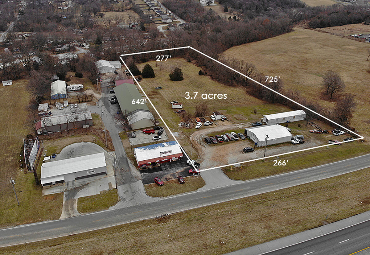 Back on the Market-No fault of sellers or property.  Unlimited Possibilities on this 3.7 ACRE outside of the City Limits w Business Building that has been used as an Automotive Business for many years, it also has an office & restroom.  Excellent Location with all Utilities.  Would be great for a Storage Unit Location!  Seller would consider leaving Manufactured home.  Could work & live there.