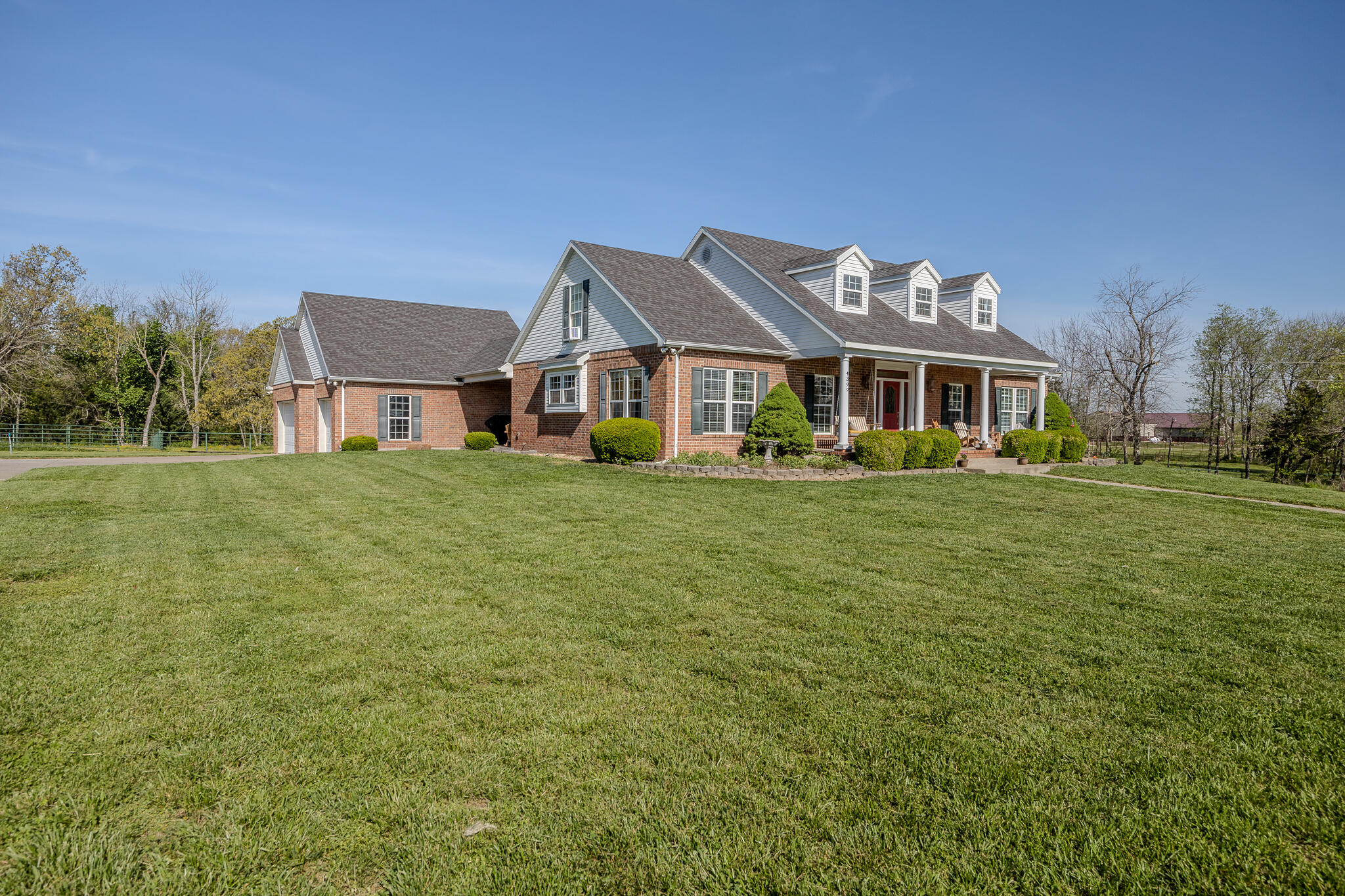 This wonderful slice of country living is looking for new owners!  The property boasts of a spacious 2 story home with walkout basement, and sits and 4 acres, just minutes from the Bolivar square.  With 4 conforming bedrooms, and a non-conforming 5th bedroom, you'll have plenty of space to fit your entire crew. This sturdy home is up-framed using 2x6 construction providing a stronger build and better efficiency, with the current average electric being under $250/month!On the main level you'll find a spacious living room with high ceilings, large windows, and a fireplace, giving you a grand and inviting feeling as you walk through the front door.  Just off the living room is a large kitchen with an oversized island, and a beautiful dining area with beamed ceilings.   Just through the kitchen is a large laundry room, right next to an exterior door, making this an ideal mudroom.  Also on the main floor is a spacious primary suite, with walk in closets and a large bathroom.On the second level you'll find a bathroom and two additional bedrooms, one of which has a unique space through a closet that you can let your imagination run wild with!The fully finished walkout basement has two more bedrooms (one non-conforming), two separate living areas and plenty of storage.  You'll be hard pressed to find a more spacious home!Outside are 4 beautiful acres, some with pipe fencing and the rest enclosed with wire.  The large pole barn is great for toy storage, and even has some stalls for small livestock.  There's also a large garden on the south side of the property, and a large chicken coop, making this a great option for someone wanting a small hobby farm or homestead.   Couple that with the large 3 stall garage and covered patio, making the outdoor space incredible!Located in the sought after Bolivar School District, this is your chance to snatch your forever home.  Call your trusted real estate agent to schedule a showing toda