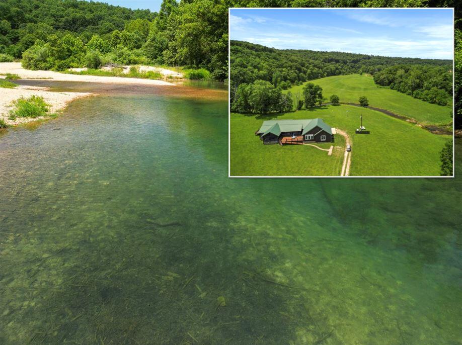 Welcome to Reynolds County where the serene Whippoorwill Ranch eagerly awaits its new owners. This remarkable property seamlessly blends rural charm with modern comforts, offering a haven for nature lovers amidst its picturesque surroundings. There is a spring in the backyard that flows into a year-round creek that runs along the property!Property Features:406 acre estate offers a harmonious blend of verdant pastures and majestic, marketable timber.Enjoy the serenity of significant live water with a spring in the back meadow and meandering behind the lodge to empty into the clear water creek. The view of the spring is amazing.The main residence features a metal roof and most of the lodge has hardboard siding (with quality vinyl on the unseen south end) for durability and low maintenance.Relax in the screened front porch with a vaulted wood ceiling, adjacent to a large entertaining deck perfect for gatherings.Screened in porch on both sides of Great Room with French Doors that opens the area for amazing fresh air entertaining!Interior Highlights:Stay cozy by the stack stone fireplace with a wood insert and plug-in convenience.Two kitchens to cater to your culinary needs:Entertaining kitchen with a gas range, maple colored cabinets, large island, and a butler's pantry with wet bar.Working kitchen with maple and white cabinets, island, whole house fan, washer-dryer hookup, and pantry with laundry chute.Unique built-ins and planter shelves adorn the home, offering both functionality and aesthetic appeal.Enjoy breathtaking views of the ranch through windows and glass doors throughout the residence.Bedrooms and Baths:Four bedrooms and four baths, including a luxurious master suite with TV, built-ins, walk-in closet, and separate his and hers bathrooms.