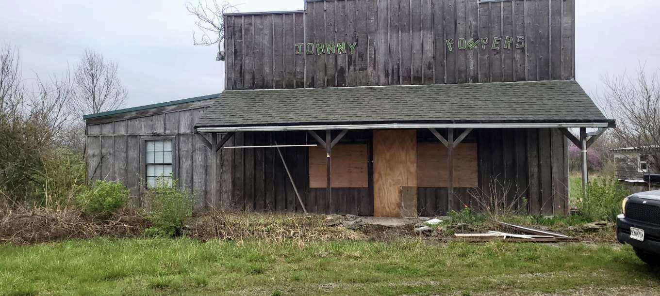 KNOCK KNOCK! Opportunity is here. 4.5 Acres on busy State Highway on southern end of Stockton Lake. There are 2 wells and septic on the property. The main building was previously a restaurant and all contents go with the sale of the property. There is a 6100 sq ft shed that could make a great place for storage or even a  flea market. Or even a RV Park. Come Check It Out!!