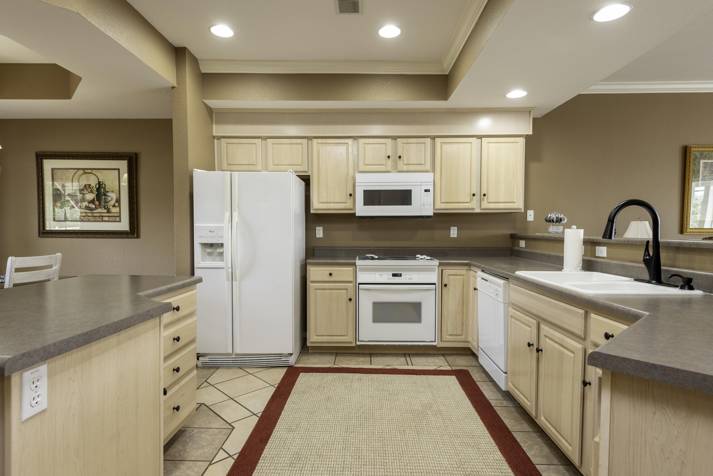 Discover the perfect retreat in this gorgeous WALK-IN vacation-approved 2-bedroom, 2-bath condo located in the heart of Branson. The moment you step inside, you'll be captivated by the warmth and charm of the open living space, ideal for both relaxation and entertaining. Enjoy your morning coffee or host friends and family in the welcoming enclosed sunroom, which offers a serene view and a peaceful ambiance. This meticulously maintained condo is sold fully furnished, allowing you to move in seamlessly and start creating new memories right away. Its prime location means you are just a short distance from the iconic 76 Strip, where you'll find a plethora of dining, shopping, and entertainment options, ensuring there's always something to do. With all these fantastic features and nearby attractions, don't miss out on this amazing opportunity for relaxation, fun, and endless adventure!