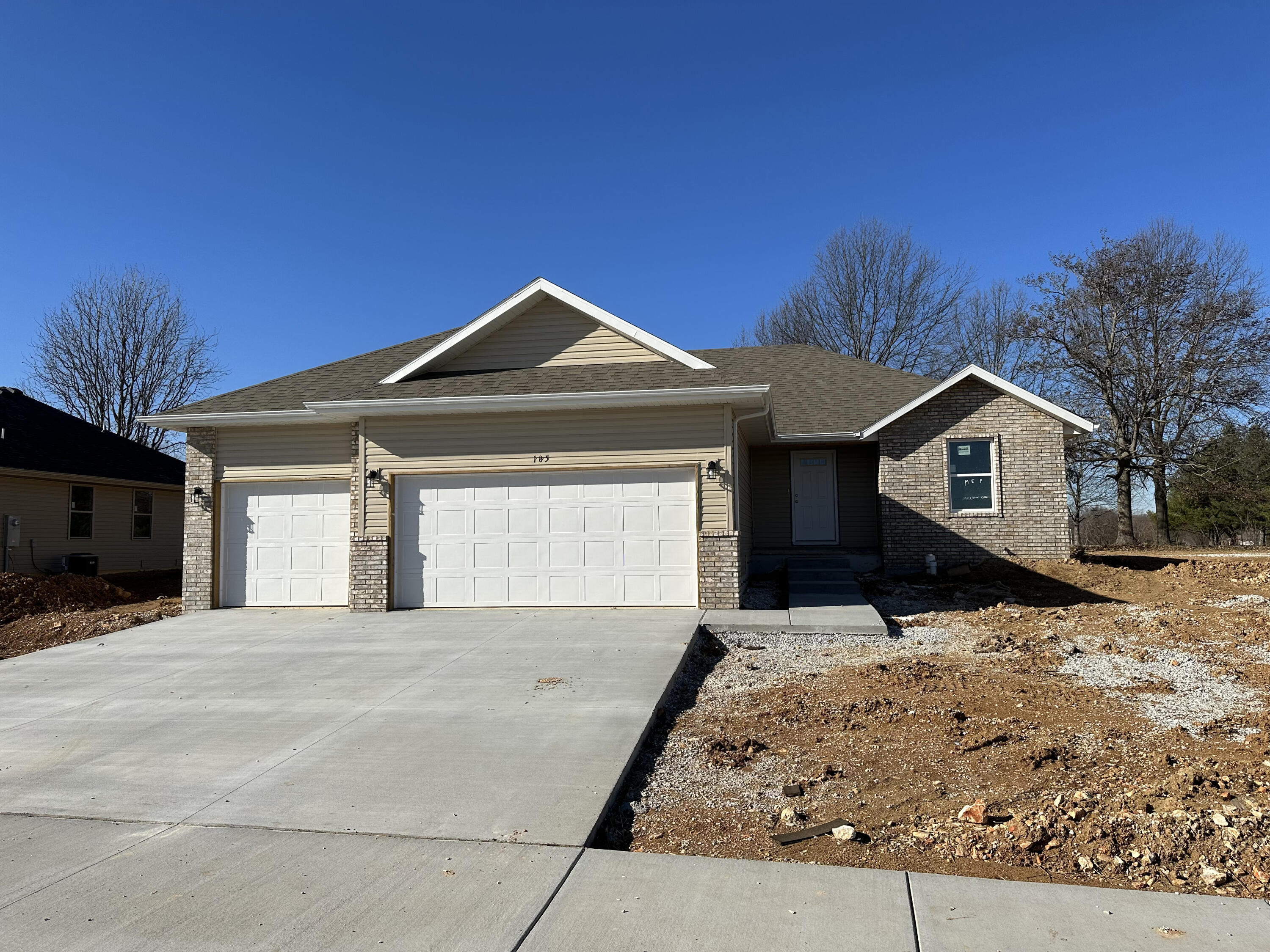 New3 car garage split bedroom plan home with vinyl plank flooring in the kitchen and living areas, large kitchen island, granite countertops, walk-in pantry, raised ceilings, covered patio and landscaping. More new homes under construction in this subdivision. All interior photos are from a similar home.