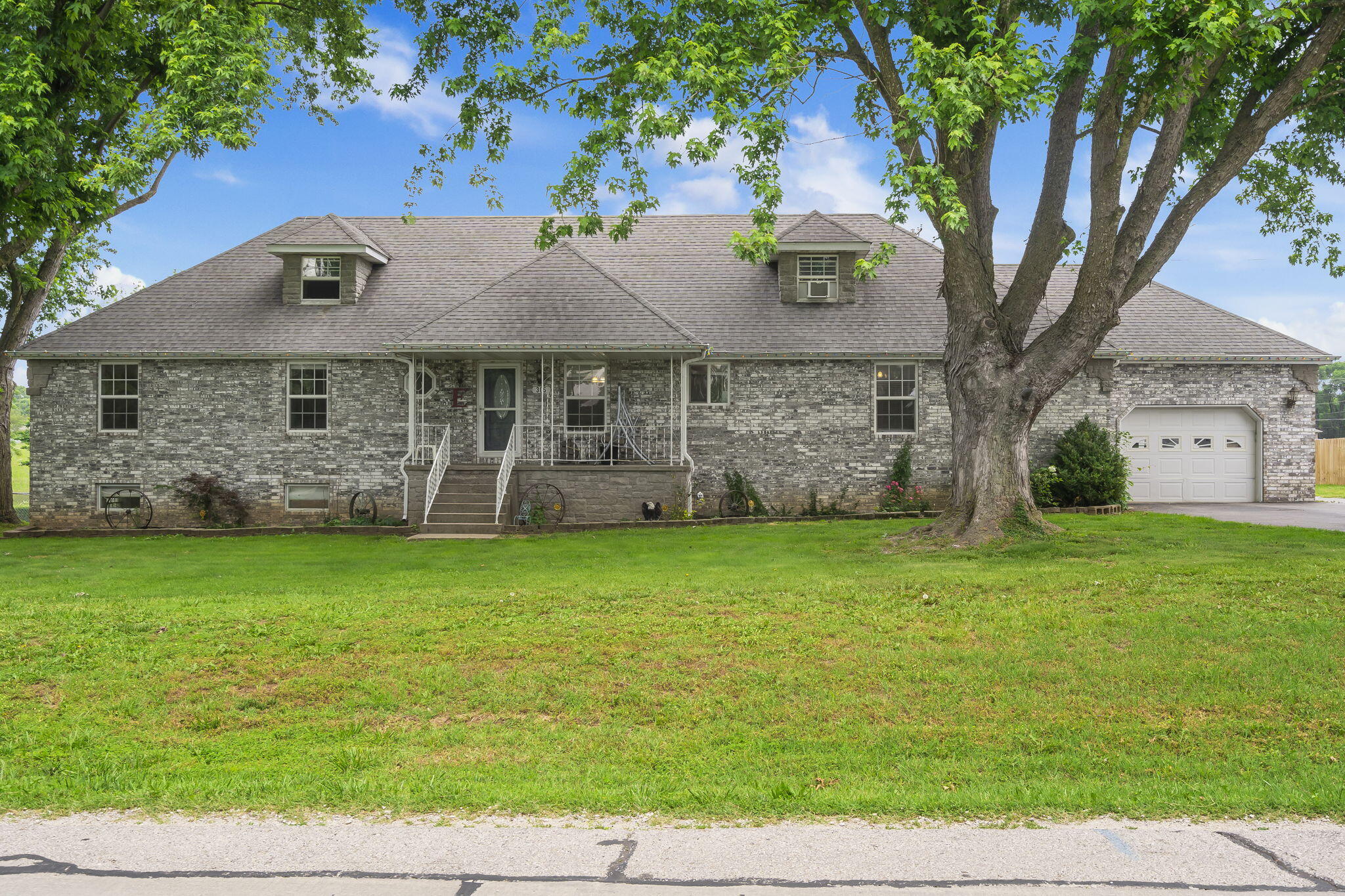 Welcome to this quiet setting on Hughes Road in the Willard School District! 305 W Hughes is nestled on almost half an acre complete with a fenced in back yard, above ground pool with wrap around deck, a 1 car attached garage and a 2 car detached garage. The covered front porch is the perfect greeting to this almost 4,000 square foot home. When you walk in the front door, you have a large entry way into the living room and the staircase to upstairs. Off the living room to the right you have the kitchen and dining room equipped with lots of cabinets and entry on to the back deck! The primary bedroom and bathroom feature a walk in closet, walk in shower and soaking tub. The laundry room is plumbed for a half bathroom and has ample space for storage coming in from the attached garage. On the other side of the home, you have 3 additional bedrooms on the main floor and am oversized bathroom to accommodate. Up the stairs there are two more bedrooms and a full bathroom with a walk in shower! Downstairs you'll find even more room to entertain with a large family room, more storage space, wet bar and access to walk outside and relax in the pool!