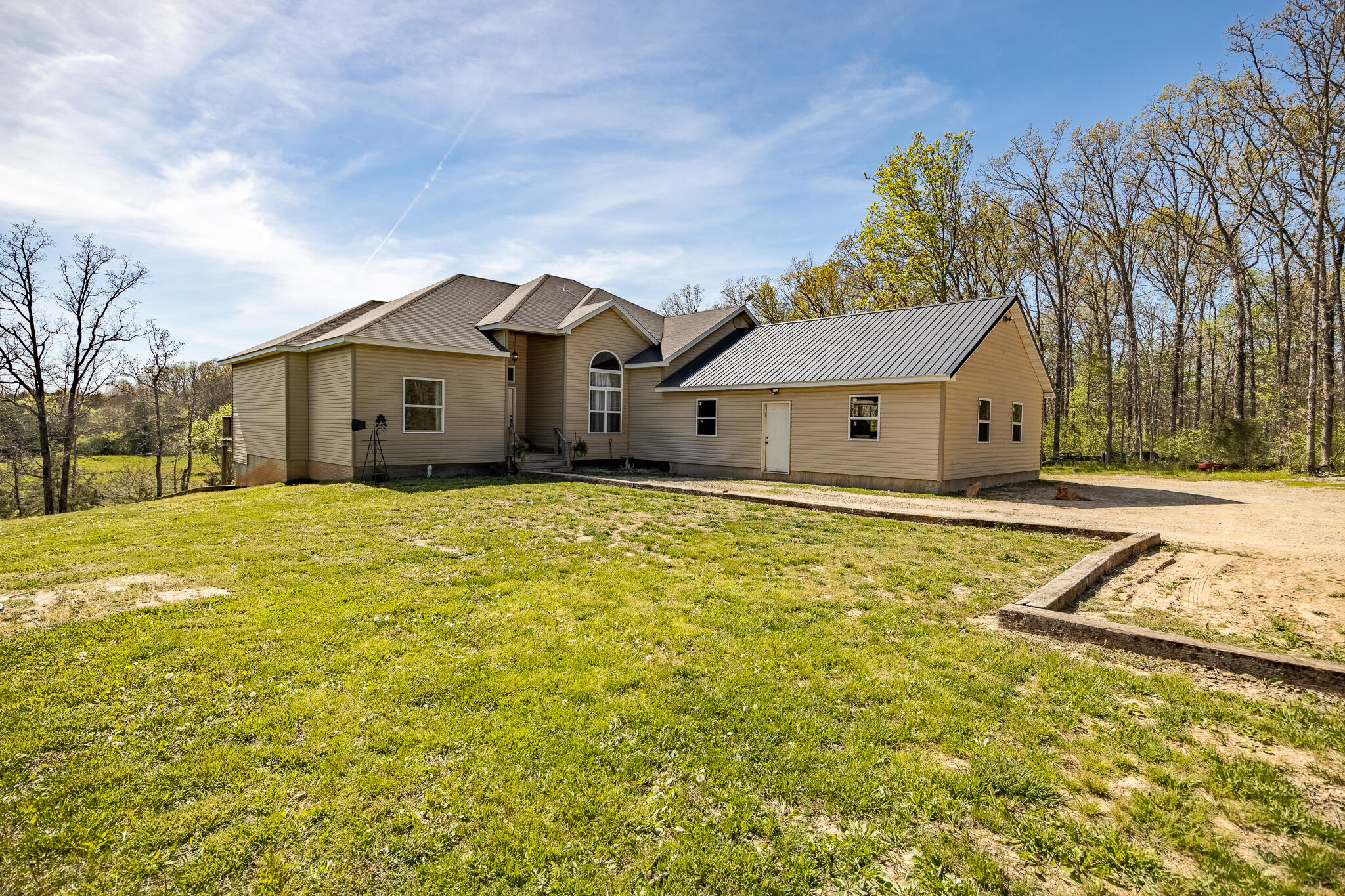 Beautiful custom home with great views on 75 private acres! This 6 bedroom 4.5 bath walkout basement home has custom features throughout. Nice hardwood floors throughout the main level, 13 foot ceilings in the living and dining room, great open concept with a split floor plan. Large open kitchen with white cabinets, granite, tiled floors and large eat in dining area, with a separate formal dining room. The master suite has a private deck, large on suite bath with a jetted tub, walk in shower, double sinks and walk in closet. Upstairs is a second large master bedroom with its own private on suite bath. The basement has been recently finished with two more HUGE bedrooms (1 non conforming). Enormous open living room/family room along with a separate dining room space. A second full kitchen is in the basement with granite counter tops and plenty of storage space. The basement has carpet and vinyl floors throughout. The ceilings will be finished in the next week or two with tin and all trim work will be completed. The house is heated and cooled with a zoned geothermal unit. Outside you will see the newly finished two car garage and the back porches are both covered with tongue and groove pine ceilings. Acreage is mostly wooded with a bottom field running through the middle of the property, a few wet weather creeks and nice size pond.