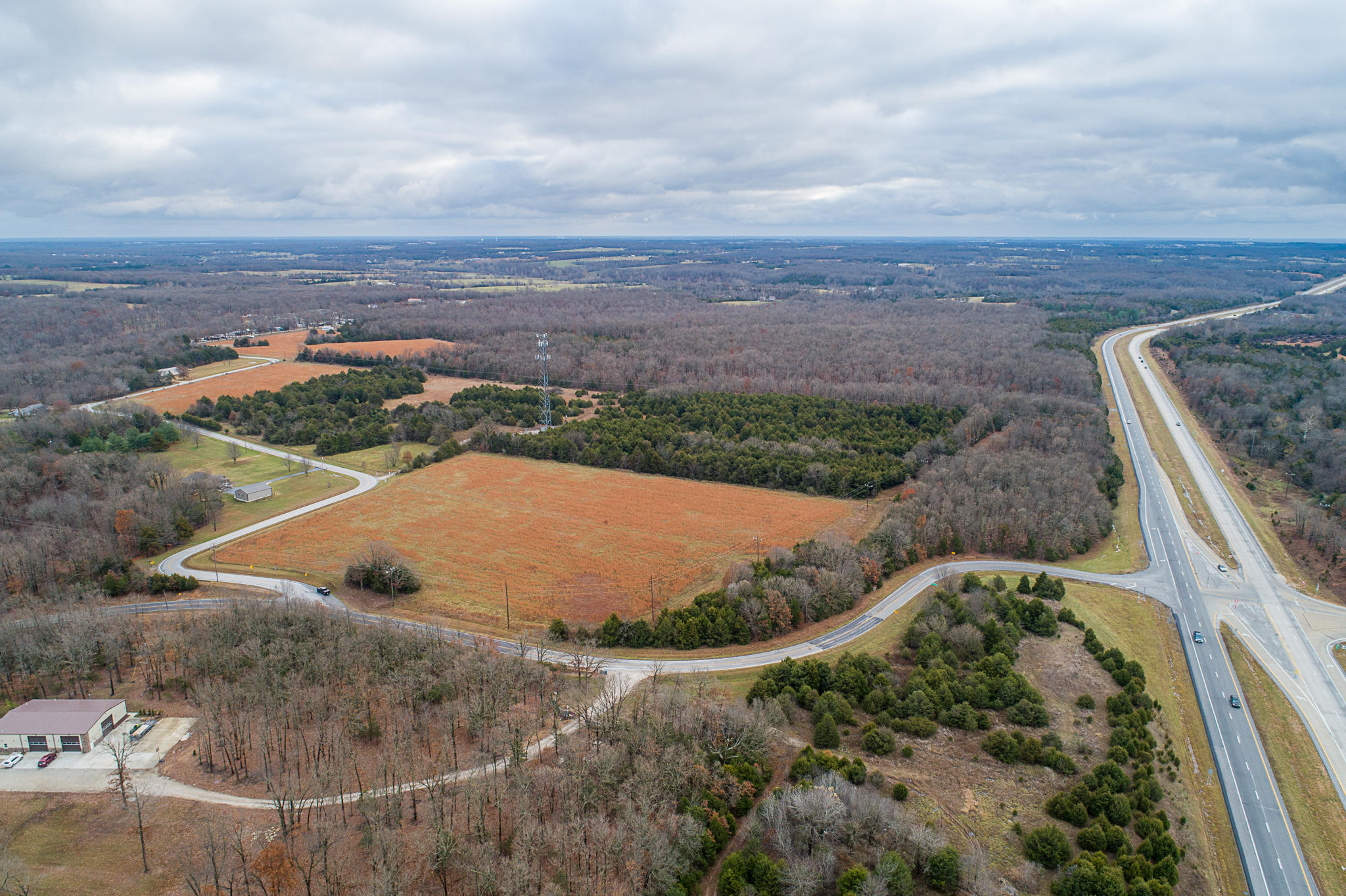 7481 N. Farm Rd. 209, Strafford, MO. Approx 206 acres (about 80% timber and 20% cleared) located at the Southeast corner of Hwy. A and Hwy. 65 in Strafford, MO. zoned Commercial and partial A-1 Agricultural. There is a cell tower on the property that is leased for approx. $991 a month plus a 30' x 35' garage with concrete slab on the property.