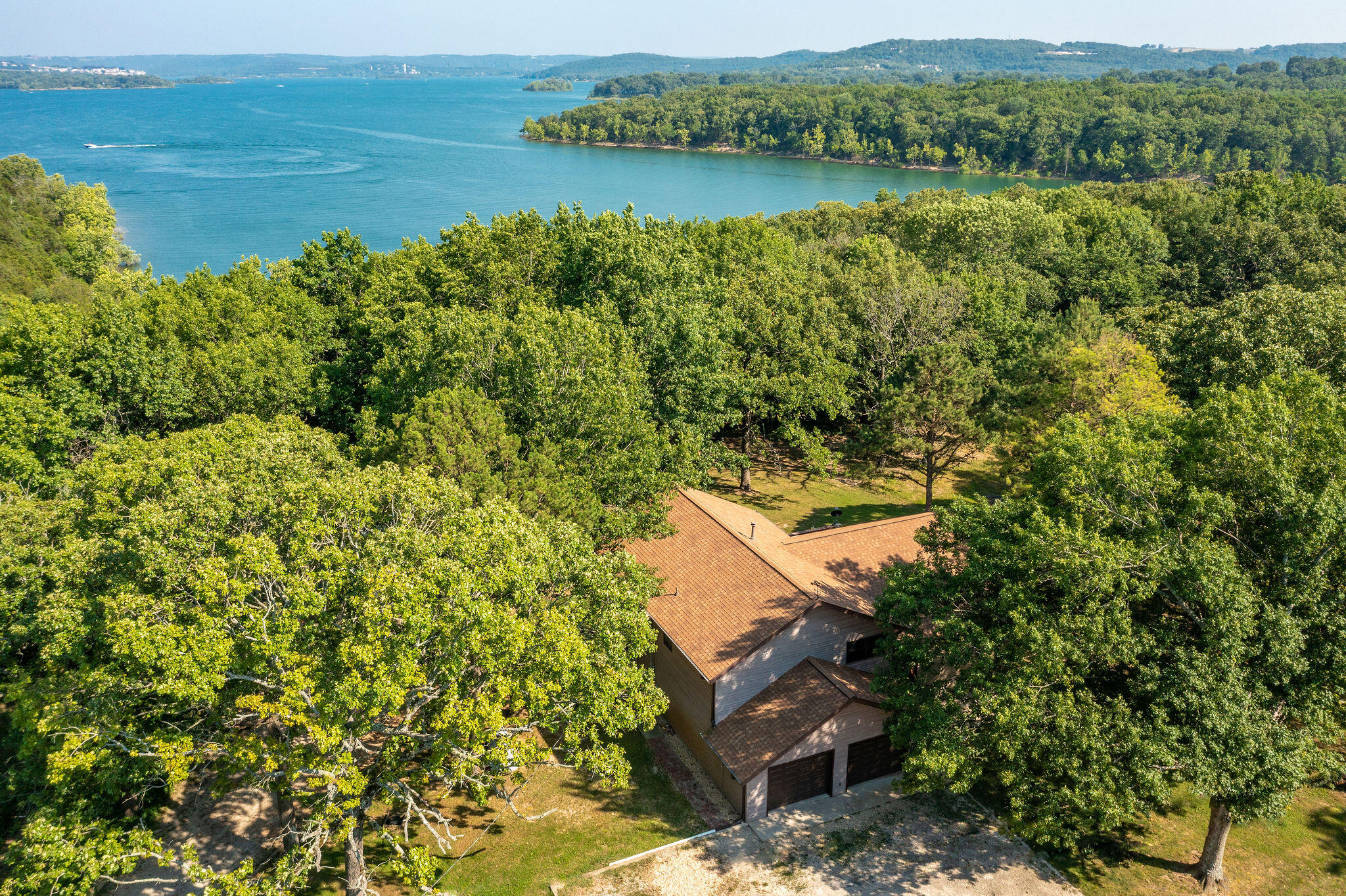 Lake front! Lake front! Lake front! So many great features at a great price. A wonderful home with plenty of space and lots of upside potential! 4 bedrooms, 3 baths, and 3000 square feet. Awesome 35 x 25 shop building with attached RV/boat parking. Take a nice easy stroll down from the house to your own lakefront oasis! Enjoy the view of the beautiful little cove from the park-like area featuring beautiful rock outcroppings. Picture you and your loved ones swimming and kayaking in the cove followed by s'mores over a lakeside campfire. Boat launch nearby, too! This is the lakefront dream in the ideal location everyone loves - along the Hwy 86 corridor close to Branson and Big Cedar Lodge.