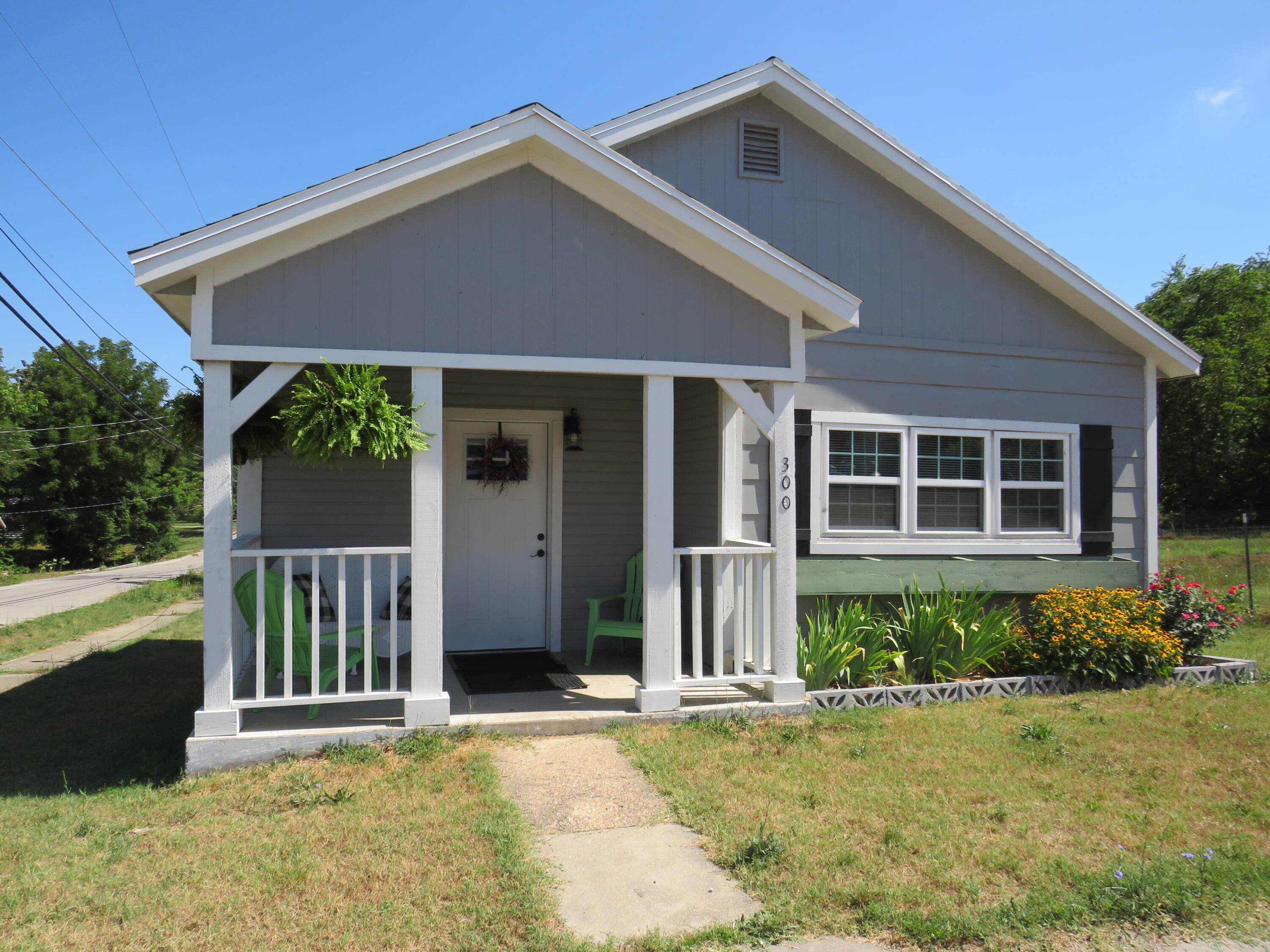 Super cute and ready to move in!!! 2 bedroom 1 bath with large living room.  The kitchen has beautiful cabinets with tile backsplash. (stove and Refrigerator will stay with the home).  Beautiful flooring through out the home, carpet in the bedrooms. Nice sized back deck and yard with a 12 x 18 storage shed.  New heating and air, New windows, new electric, new roof.  The sofa and chair can stay with the home. You will not be disappointed in the wonderful home.