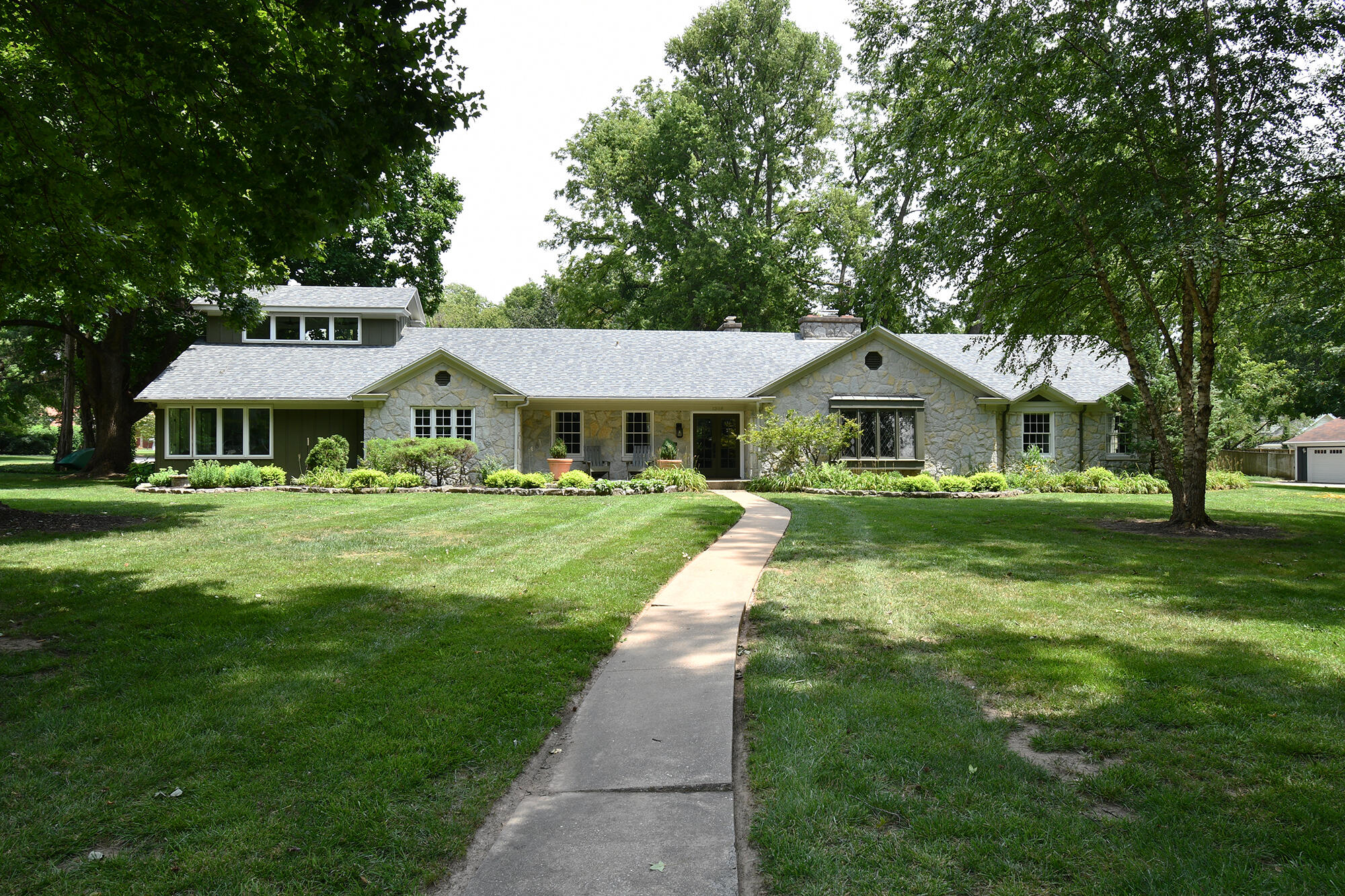 Nestled in exquisite Meadowmere Place in the heart of Rountree, this lovely contemporary cottage ranch combines classic elegance with fully renovated livability.This home has been lovingly and meticulously taken care of by families since its construction in 1951 and still retains its original charm with many modern updates.The home, which sits on nearly one acre, has 4 bedrooms, 3 full bathrooms, 4,500 square feet, and FOUR LIVING AREAS. The current owners completed a full renovation in 2021, including:  new Anderson windows, new roof, new doors-interior and exterior, lighting upgrade package including Visual Comfort Lighting selections, custom window coverings, new trim and crown molding throughout the home, an all-new kitchen featuring quartzite countertops and large island, Thermador range, convection double ovens, built in microwave, Cafe fridge, and natural stone floors, two renovated bathrooms, refinished original hardwood floors, stone facade of the living room fireplace, wine closet and built in bar, which includes a wine fridge and soapstone countertops, and a large built in bookcase in the family room. The Principal ensuite and bathroom/ closet/ laundry were renovated a few years ago as well.The home lives elegantly and easily with the majority of the square footage on the main level. Great for entertaining, families, or retirees.The lifestyle is unlike any other in the City of Springfield. Living on the private drive of Meadowmere Place is simply charming, with beautiful, manicured homes and gardens surrounding you on every side and a walkable, friendly lifestyle.You are within walking distance to Cherry Street commerce, Phelps Grove Park, Springfield Art Museum, and Delaware Grade School. You are also extremely close to the Downtown arts and entertainment, restaurants and theatres. If you want to live a charmed life, this is the home for you. --
