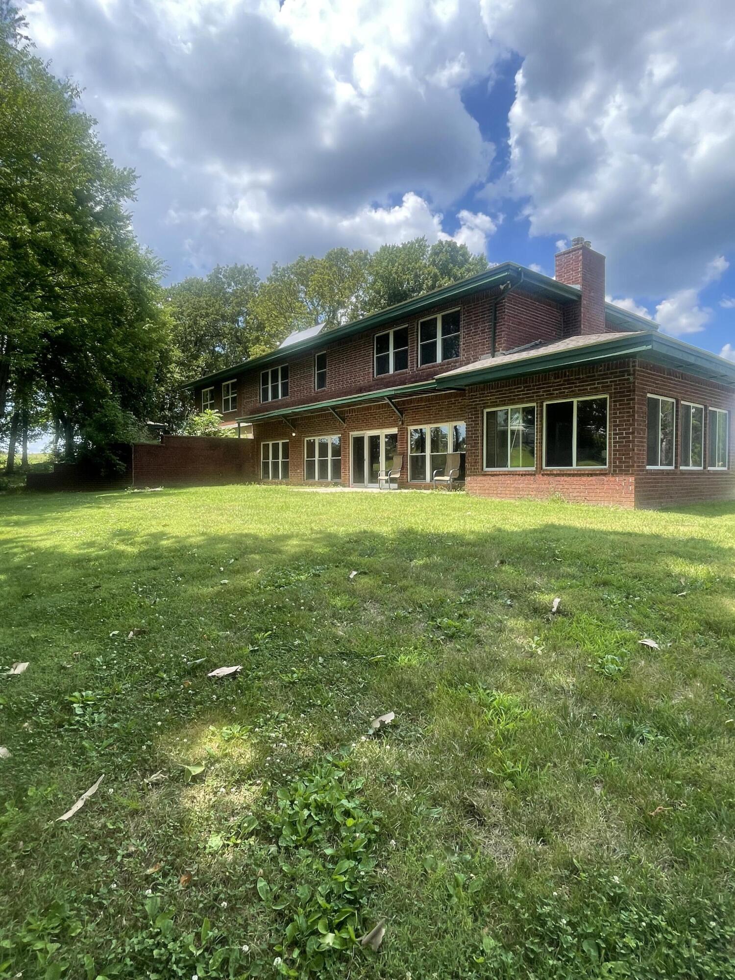 Very well constructed, All Brick, Energy efficient Home on 40 +/- Acres, Pasture. Woods. springs.  3 bd with great possibilities of additional bedrooms.  4 1/2 bath. External walls are 1 ft thick, Whole house solar panels, plus passive solar.  New roof in 2020.  A must see property  for those that are seeking privacy and  room for livestock and hunting.    42 x 55 metal barn and small pipe pen.