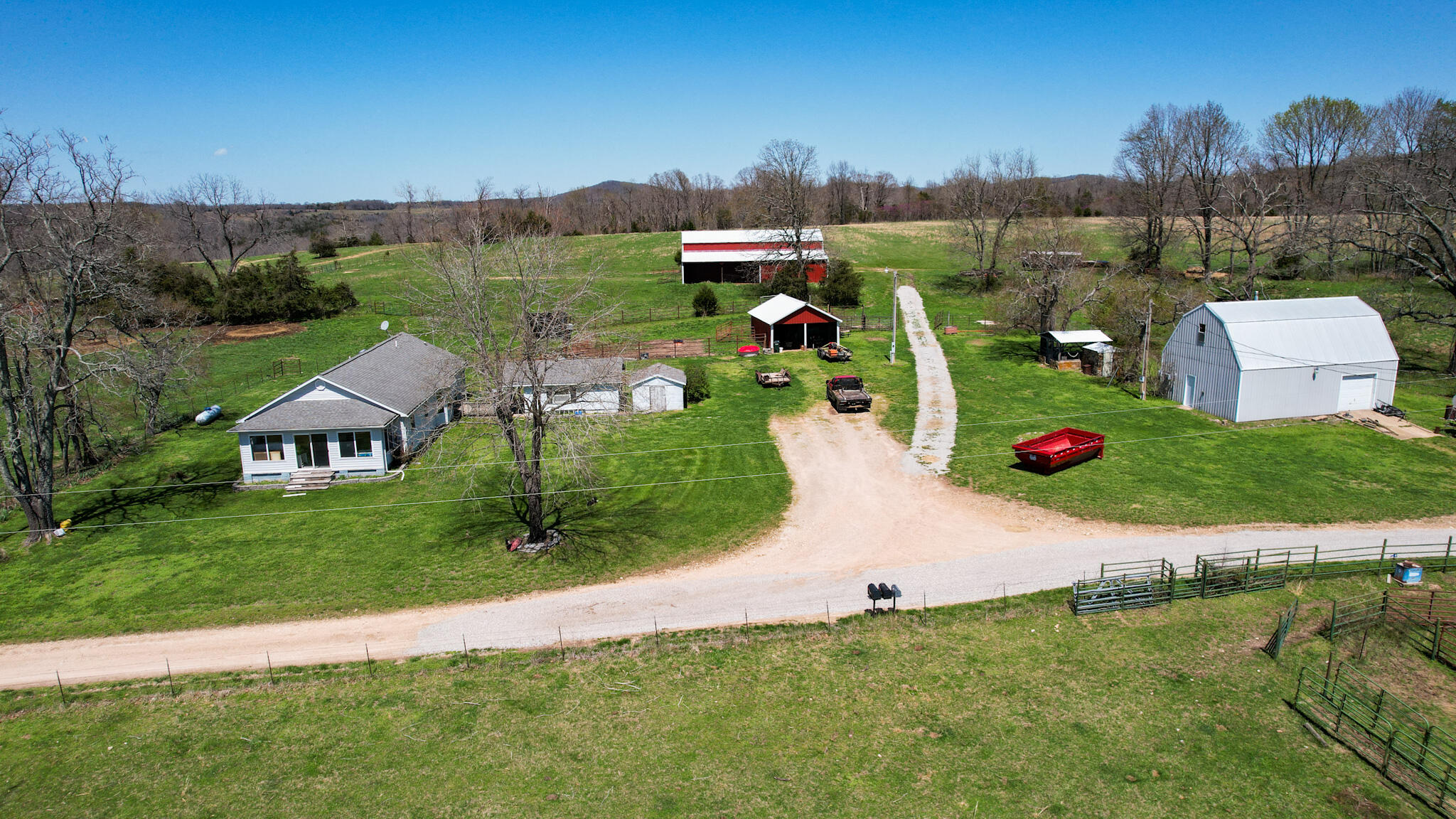 This large ranch for sale is located in the Ozark Mountains of Ozark County Missouri. There are 1,124 acres known as 'Timberknobs Ranch' 500 of these acres is pasture land, and 600+ acres is wooded. One mile of this property joins the Caney Mountain Game Refuge which is Missouri Conservation land. This piece of land has amazing features including gravel road frontage, year-round creek, 2 large springs, many smaller springs, 10 ponds, 9 separated pastures used for rotating grazing, excellent fencing, 60 acres of bottom land and hay ground & more! The pasture land fencing has steel posts and 5 barbs with metal corners. The bottom land has the creek flowing along the edge. There are several trails through the wooded areas, some commercial sized timber, and a large spring fed pond. This is one of the best hunting lands & could be right out your back door! The property has a nice 3 bed 2 bath home with many out buildings. It's not fancy but a nice farmhouse. A second house called 'the hunting cabin' features 2 bedrooms, 1 bath and is in good condition as well. It has some remodeling including a new roof, front porch, vinyl siding and more. This ranch has been in the same family for over 100 years! It is considered a century farm. There is a current tenant that lives in the main house and leases the land. He would be willing to continue in that capacity. This is a rare opportunity to own acreage of this size with as many amenities for less than $2250 per acre. Taxes are only $1 per acre per year. This is a private setting only 1 mile from a paved road, 8 miles to Gainesville & 25 miles to Ava. This is great for cattle, or a hunting retreat. Investors could turn this into a hunting reserve as the wildlife is already there and the wooded area joins over 6000 acres of the game reserve. The only access to the reserve is private joining land or the main entrance is 25 miles away. It is seldom that a property like this hits the market that joins the Caney Mtn lan
