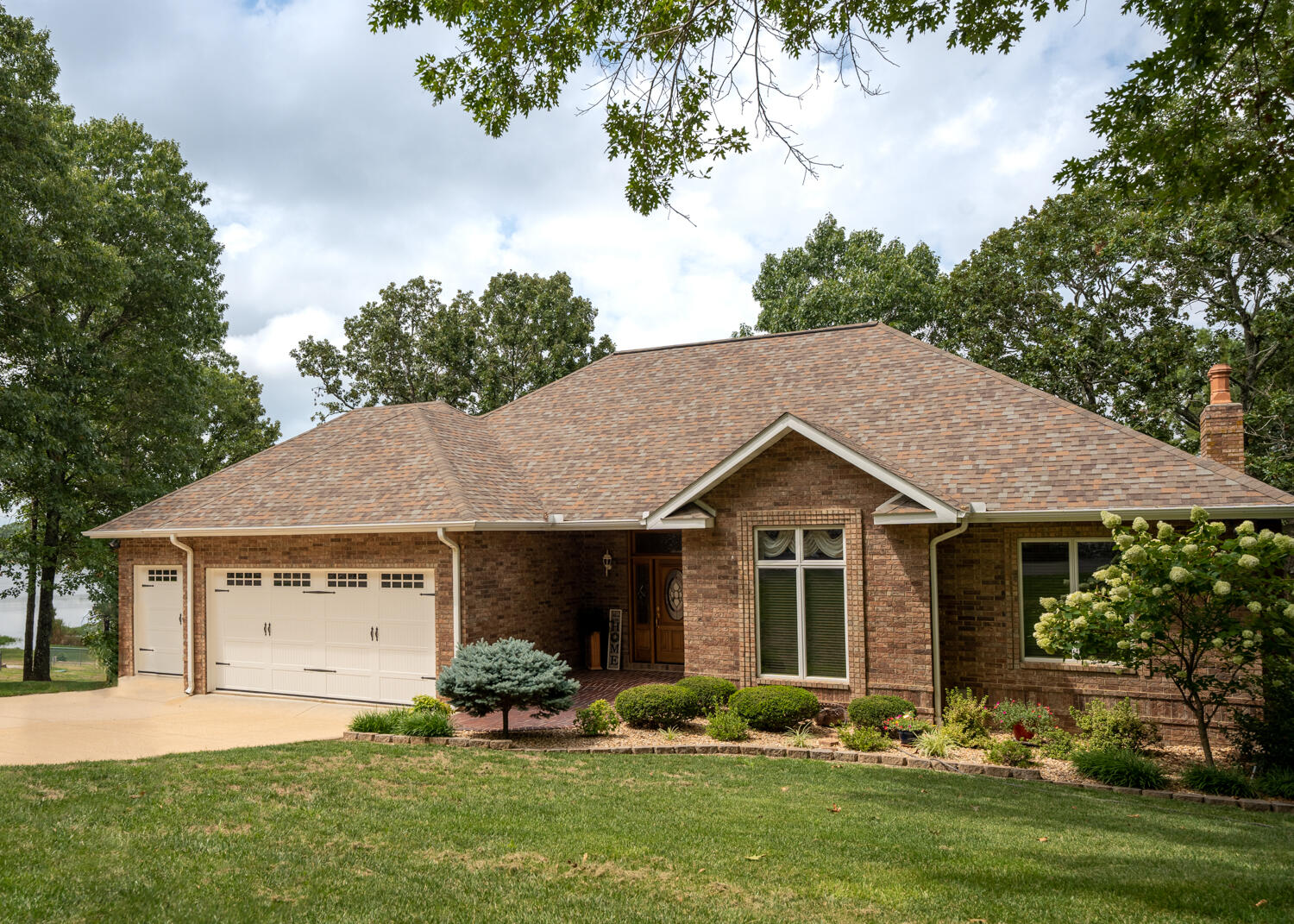 Custom designed and built luxury home with1.3 acres on Private Arrowhead Lake sitting just outside of West Plains, MO. 4 bedrooms, 3.5 bathrooms, library/den, family room, living room, 2 sunrooms, laundry, kitchen and dining room with large foyer are included in the home which was built in 1997 and has had several updates in recent years. Walkout style basement with 9' ceilings and large windows, provides natural lighting and a separate entrance.There are stunning views from many rooms with large 7' x 6' Anderson windows that over look the lake. All custom woodworking with custom made solid interior doors and large crown moulding. Main level ceilings are 10'. Angled floor plan with no narrow halls. There is a 20x40 Carport on paved pad with 30 amp breaker box for RV. Boat Dock can accommodate Pontoon Boat or be made smaller for regular boat (electric at cleaning station).  Experience lake living in luxury.