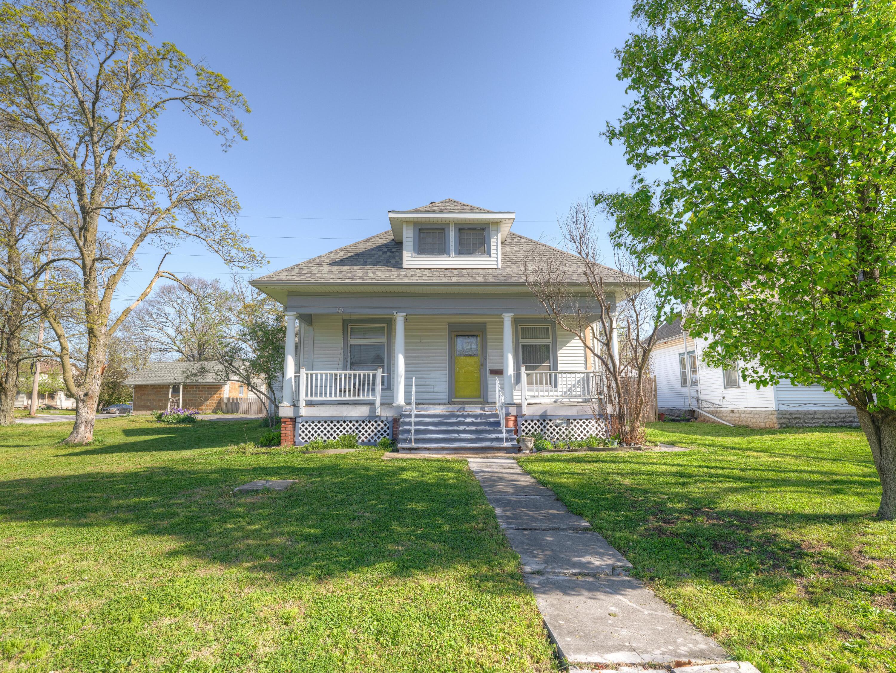 Very well maintained home with room to expand for additional living space.  This adorable home offers 1488 square foot of finished living space, with an additional 576 square feet of partially finished attic.  Currently this home offers 3 bedrooms, 2 1/2 bathrooms, bonus room, large living room with beautiful original hardwood floors.  You will love the large back yard that has full privacy fencing and multiple unique outer buildings, including a 2 car detached garage, with workshop space.  You will not want to miss this opportunity!