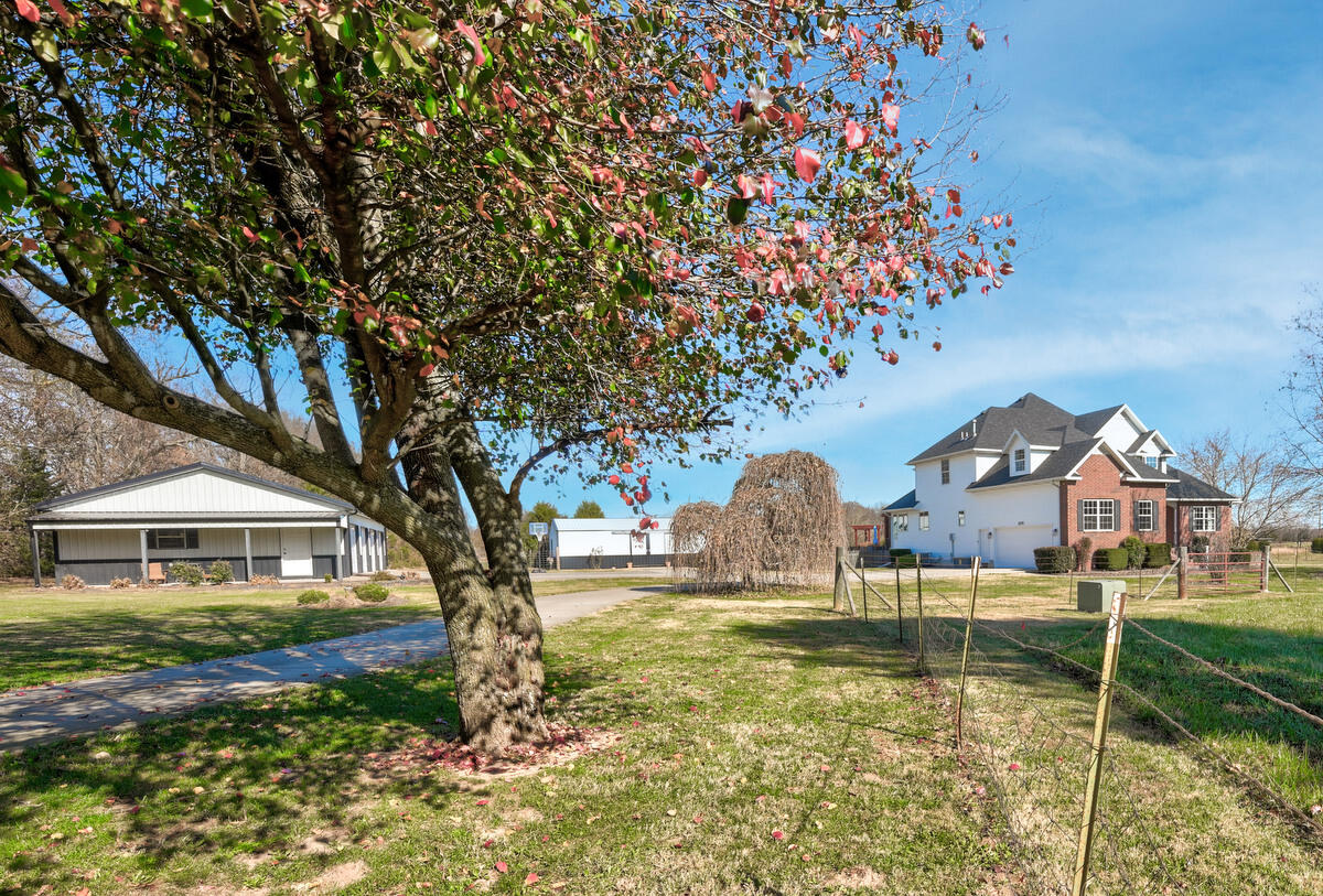 Welcome to 10 acres of country paradise with easy access to major routes like James River Expressway, West Sunshine and I-44 with swift connections to both Springfield & Republic. The 1.5 story home provides 4 Bedrooms, 3 1/2 Baths, 2 Living Areas while the full unfinished basement is a canvas waiting for your imagination to bring it to life. Perhaps a home theater, a game room or a combination of possibilities. The Entryway is highlighted by an 18' ceiling and 3/4'' solid hand-scraped Hickory flooring that flows into the Office & Living Room. The elegant Formal Dining features Brazilian Tigerwood flooring. The large remodeled Kitchen boasts Quartz counters, lots of Knotty Alder cabinets, not 1 but 2 sinks, double wall oven with convection, a gas cooktop with telescoping downdraft & a microwave with easy-open drawer. This Kitchen will definitely be the hub for friends & family gatherings as well as delightful meals. This Kitchen, with its cozy window seating, will definitely be the hub for friends & family gatherings as well as delightful meals. The main floor Master Suite is a retreat offering tranquility & luxury where you can unwind and recharge.  A convenient Half Bath is located off the Kitchen as well as the Laundry Room with Laundry sink and folding counter. Enjoy views of the morning sunrises from the covered Screened-in Porch. Meander onto the large composite deck with arbor & swing to enjoy the refreshing 16x32 oval above-ground pool within the fenced backyard.  Here you can also do a little grilling or roast some marshmallows over the wood-burning fire pit. The 30x48 Shop with a 5x30 covered Porch is equipped with a concrete floor, 4 doors with openers & both 110 & 220 making this space a workshop paradise. The 24x32 Barn has front & back sliding doors, 3 possible stalls, a frost-free water hydrant and 110 power. There are many more intricate details of this property that will promote it to the top of your list. Seize the moment & schedule your appointment.