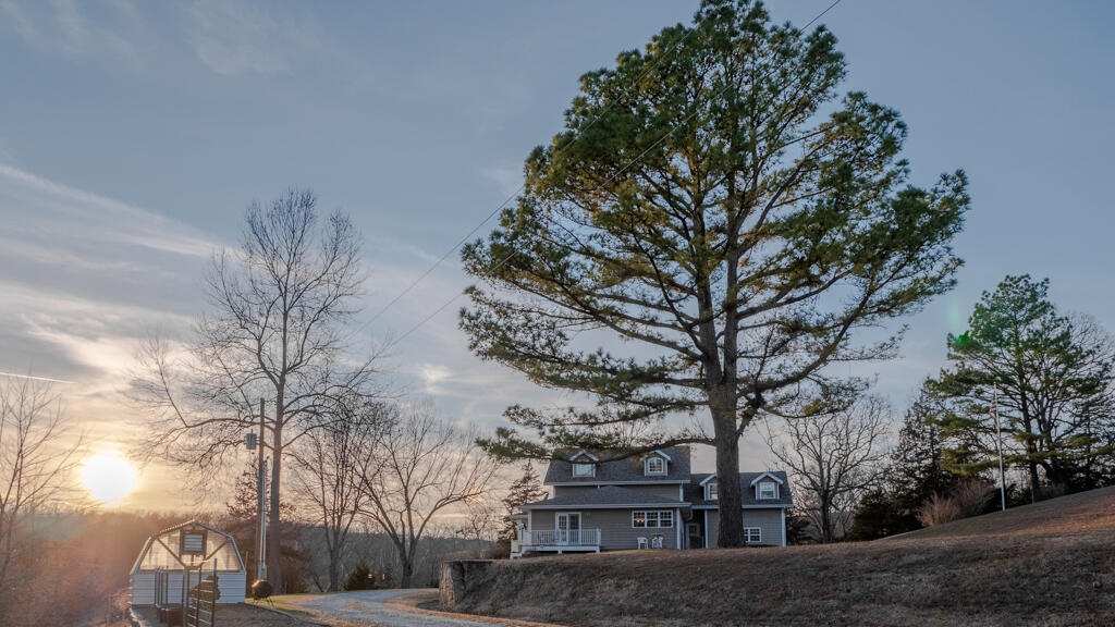 This property has so many amazing features throughout the entire 250+/- acres. The custom built home consisting of an open floor design with hardwood floors, custom cabinets, loft area overlooking the kitchen and livingroom, master suite, and open living/dining room, all built over a large finished walkout basement. The open kitchen is appointed with custom cabinets and a walk-in pantry, creating a great space for large family gatherings. The open decks and screened in porch areas are finished with Trex composite decking. The master suite has double vanity sinks, walk-in closet and a relaxing jacuzzi tub. The exterior is clad with Hardie Board  siding. The guest house comes fully furnished, equipped with a small kitchen, full bath, and two bedrooms. There's two garage stalls in the main house and two more under the guest house. The main barn has electricity, concrete floors, and an open loafing shed. The pastures are set up for rotational grazing with water available in each paddock. The grazing areas have 4-strand barbwire, and electric fence powered by a STAFIX solar powered unit. This farm has many hidden features. The cave, yes you will have your very own personal cave to explore. As you traverse  the many fenced-off pastures, you will find four different ponds. Three of which are equipped with gravity fed cattle watering systems and the fourth is plumbed and ready to be finished. Just below the house you will find the road's namesake, Toby Spring which has been recorded with the state producing a flow of 10-100 GPM. The farm offers multiple creeks, providing plenty of fresh water for livestock. This farm is a perfect set up for the avid outdoorsman. The timber is fenced off from the livestock creating outstanding deer and turkey hunting and adjoins 1700+ acres of Fiery Fork Conservation.