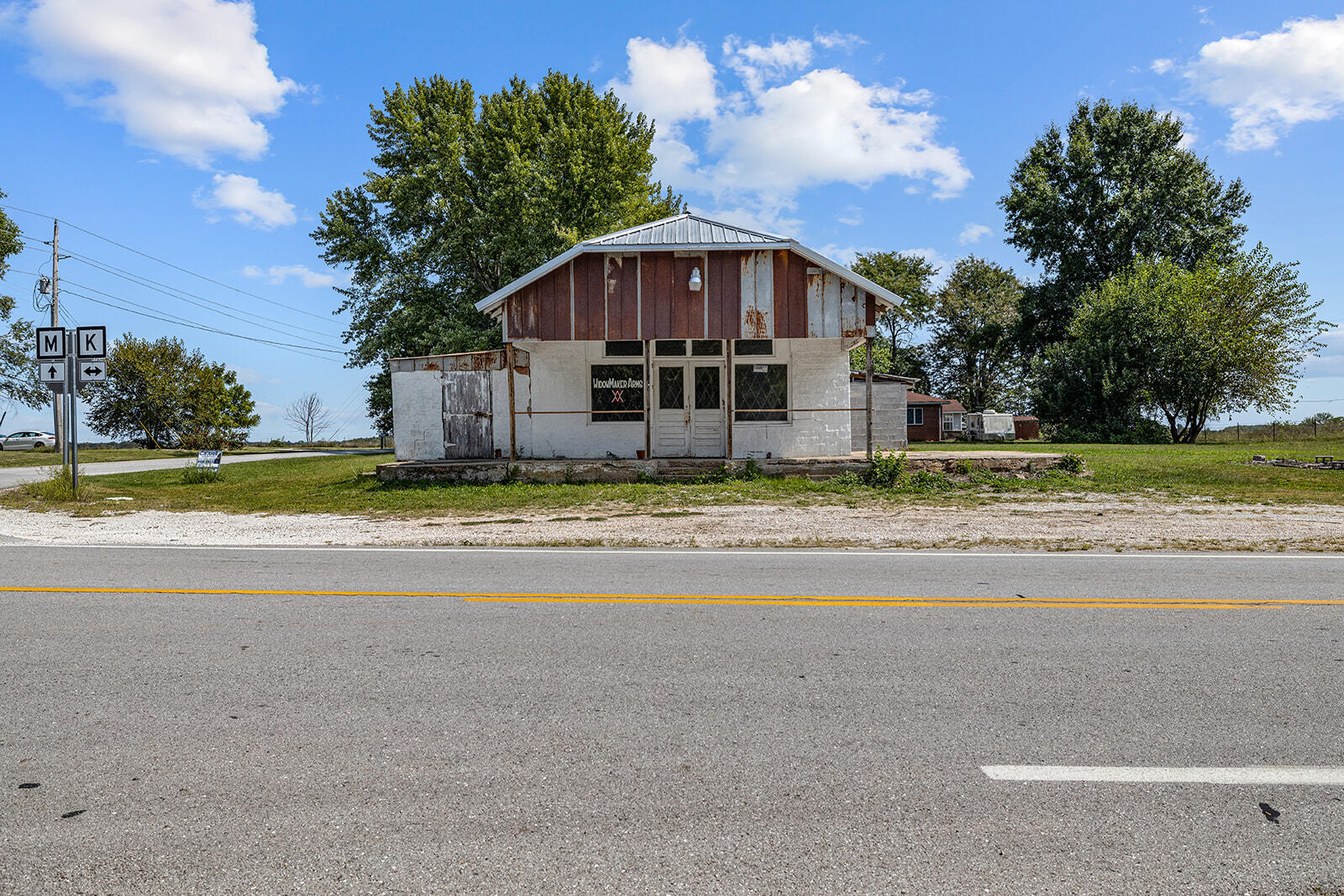 Check out this multi-use property on .42 acres with a newer metal roof! The possibilities are endless on this house/shop or just a place to store all the toys that you can't fit at the house. Property is being sold AS IS.
