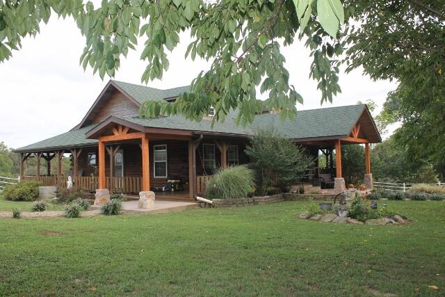 Custom Built Log Home on 113 Acres in the beautiful Ozarks! This place has beautiful long range views and great country feel. Property offers mix of pasture, woods and hayfield. Mile of pipe fencing along hwy and barnyard areas along with perimeter fencing and partial cross fence. Spring, 3 ponds and 2 waterers for stock. Land lays on both side of the hwy. and property host Main home along with 3 additional income rentals, Large 120x50 Barn w/ stalls and room for hay storage needs. 30x30 Haybarn w/lean to and 3 wells on the property. Main Home is beautiful custom tongue and groove log built home. Stunning walkup entry with open span porches on front and side of home with full wrap around decking! Walkin Living offers vaulted open beams with cedar and car siding, Kitchen has large Island w/ bar style seating and stainless appliances. Dining at end of kitchen has double door for view/access to wrap around porch and pool with full deck and gazebo for entertaining. Master suite has roomy bath with jetted tub, separate shower and large closet. Additional bedroom, full roomy bath and utility w/ outside entry on main level. Full finished basement offers mechanical room with storage, 2-3 bedrooms (1 unfinished space), full bath and end of home walkout large Family room and rec area with pool table. Home has been immaculately kept and pride of ownership shows. Beautiful shade trees, shrubs and perennials adorn the front yard. OWNER NEEDS 24 NOTICE DUE TO TENANTS Call to reserve your showing! $700,000.