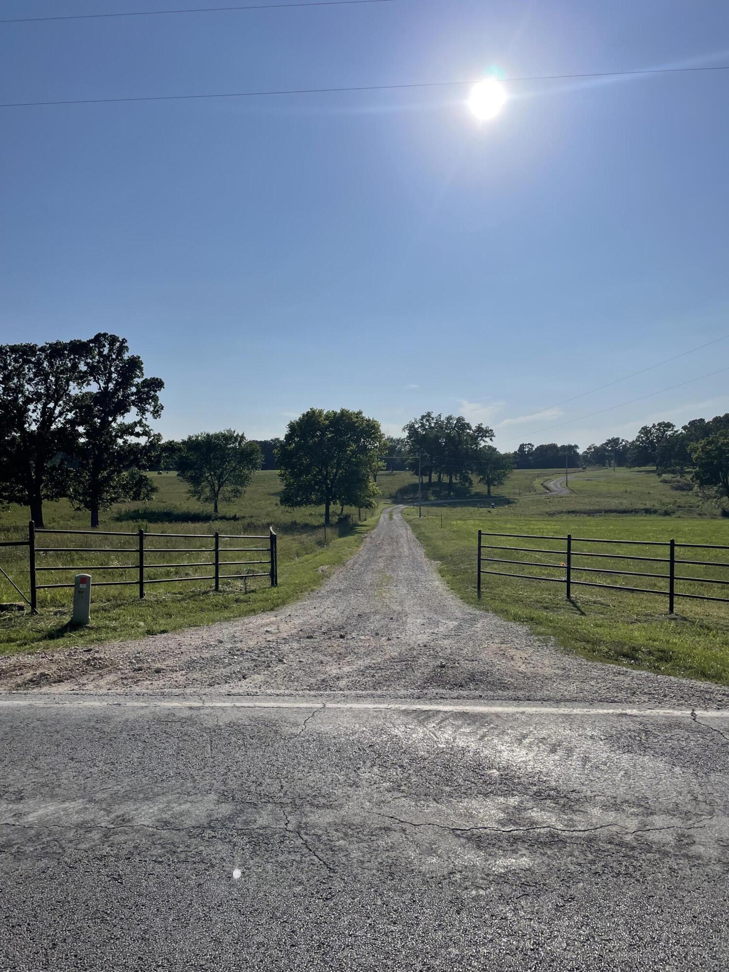 Looking for land to farm, hunt, and enjoy piece and quiet while being 5 minutes to town? Then this is the perfect place for you! Beautiful 110 acres that is the perfect mixture of open pasture, hay field, and wooded areas. There is perimeter fencing with electric cross fencing, 4 ponds, wet weather and spring fed creek going through the bottom. Great hunting spots for all of the hunters or if you just enjoy watching wildlife. This place has an additional well used for cattle, cattle corral, 40x100 hay barn, 40x80 machinery barn, and 40x30 shop w/ concrete floors and wood stove! There is electric in all barns/shops. This is a great turn key cattle farm! Highway frontage on two sides that can serve to be easily sub divided.  This piece of heaven offers a 2021 3 BD/2Bath mobile home with open living/kitching/dining area. Unwind and enjoy the beautiful view from the large 16x30 deck.  The main well and 4 bedroom septic is only two years old. Not staying: Fridge in shop, free standing panels, cattle chute, alleyway, 90 degree tub. Come take a look for yourself and see all of the amazing opportunities this area has to offer! Owner agent.*There are a couple of drawers being sent to replace the missing ones*