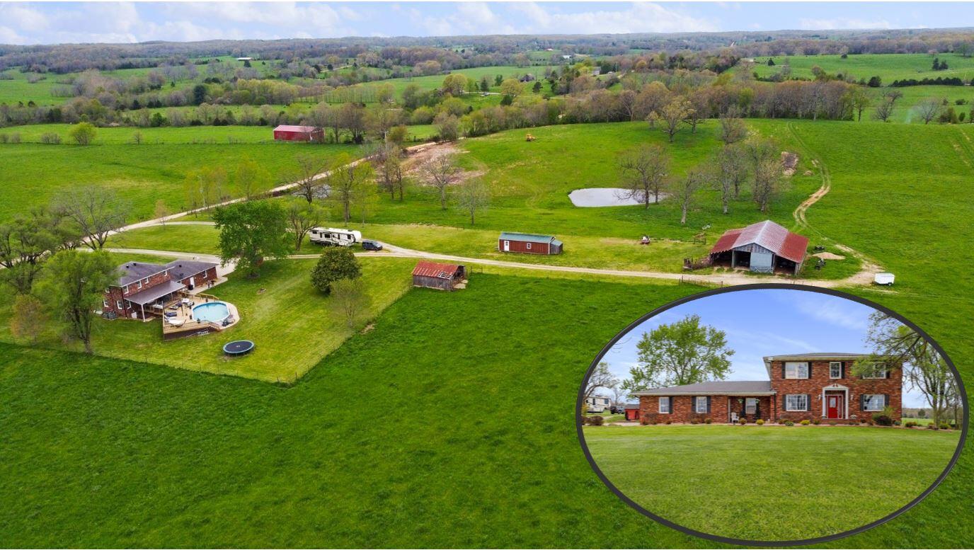 Gentleman's Farm for Sale in the Missouri Ozarks.  This farm is located in the Peace Valley area just a few miles outside West Plains City Limits in an area where you can get to know your neighbors but remain secluded.  This is one of the most beautiful, manicured farms in the Ozarks!  It is set up for rotational grazing with 6 piped auto-waters and ponds for your livestock.  There are two wells, large haybarn approximately 25x80 with equipment lean-to on each side, and a few other outbuildings.  This is some of the best pasture ground you will find in the Ozarks - high producing and very well maintained.  It will run 50 head plus cut hay with regular fertilizing and pasture maintenance practices.  Beautiful 2 story home with walkout basement features 3-4 bedrooms and 3 baths.  Open concept with fireplace and large gourmet kitchen with granite countertops, glass tile backsplash, fabulous island bar, large pantry and beautiful hardwood floors.  The home is set-up wonderfully for family with large entry and locker/mud room off garage with a large utility room and storage space.  Primary bedroom is large and features ensuite bath.  Family room, office, possible 4th bedroom and plumbed for 4th bath in basement.  Oversized 2-car attached garage.  Ultimate in outdoor entertaining on covered multi-level deck with pool.  There is a spacious covered area for grilling and entertaining with a beautiful sun area around the pool.  Really cool area with views of one of the most beautiful farms in the Ozarks!