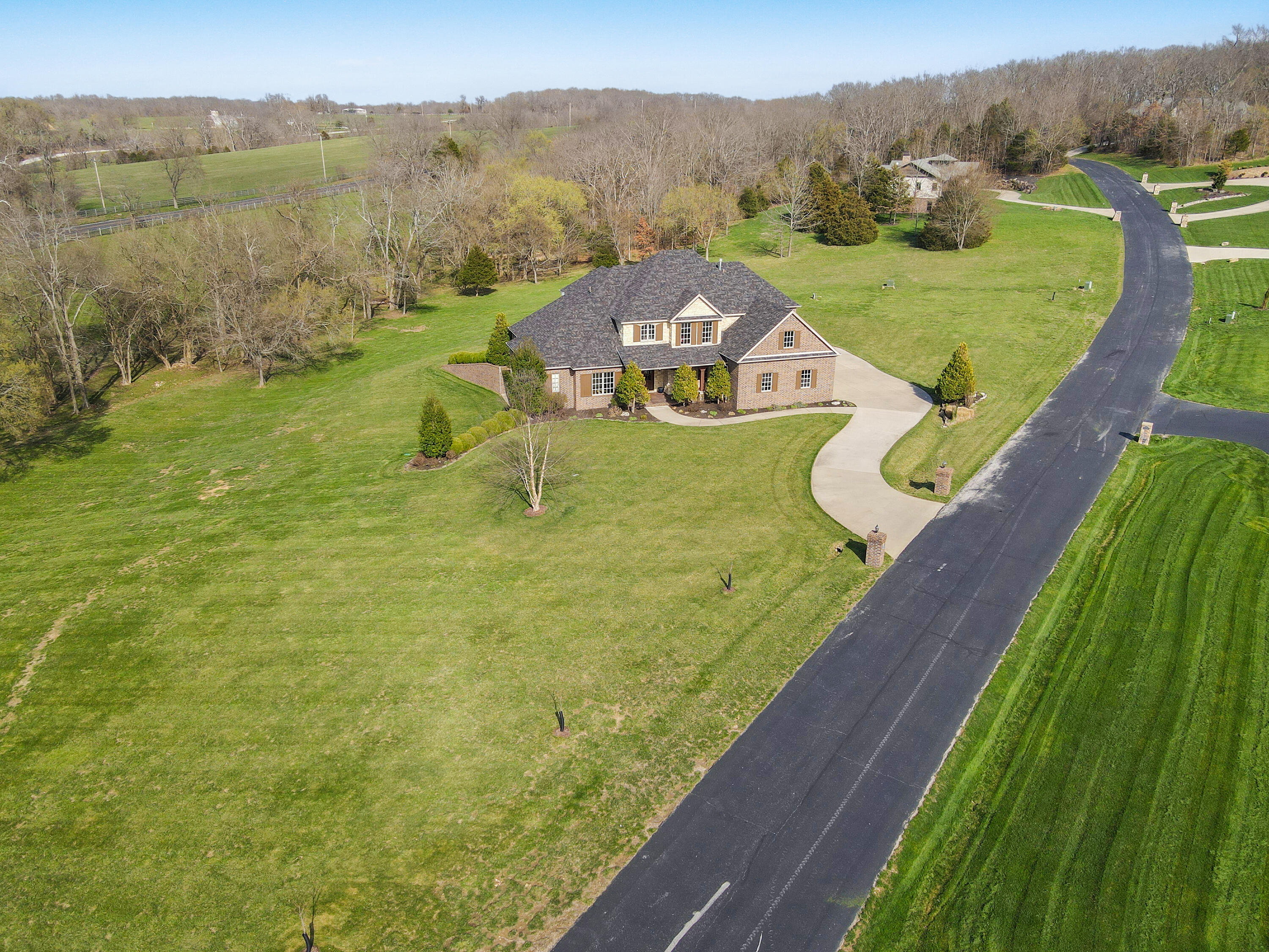 NIXA SCHOOLS!  Amazing custom built home located in a gated community with with only 10 homes all on 3-5 acres. The subdivision sits on the Finley River and has private access to the river. The home is conveniently located between Ozark and Nixa and less than 10 minutes from Walmart, Lowes and so many restaurants. As soon as you pull through the gates for the subdivision you will fall in love with the setting. The home sits on over 4 acres and offers trees, wet weather creek and plenty of open areas as well. New roof 4 months ago.  The entry way boasts an open stair case over looking the two story living room with fireplace and a wall of custom built ins. There is extensive mill work through out the whole house, beautiful kitchen with high end appliances, a ton of cabinet space, island, bar and large walk in pantry. There are 3 wet bars throughout the house with refrigerators at each one. The main level features the master bedroom with amazing ensuite with separate sinks and make up counter and large walk in closet with plenty of built ins. There is a great office (could be used as a bedroom) on the main level. The second level features 4 bedrooms, play room, 2 bathrooms and one of the wet bars. The basement has a huge living room with room for a pool table and living area, another wet bar and a work out room.