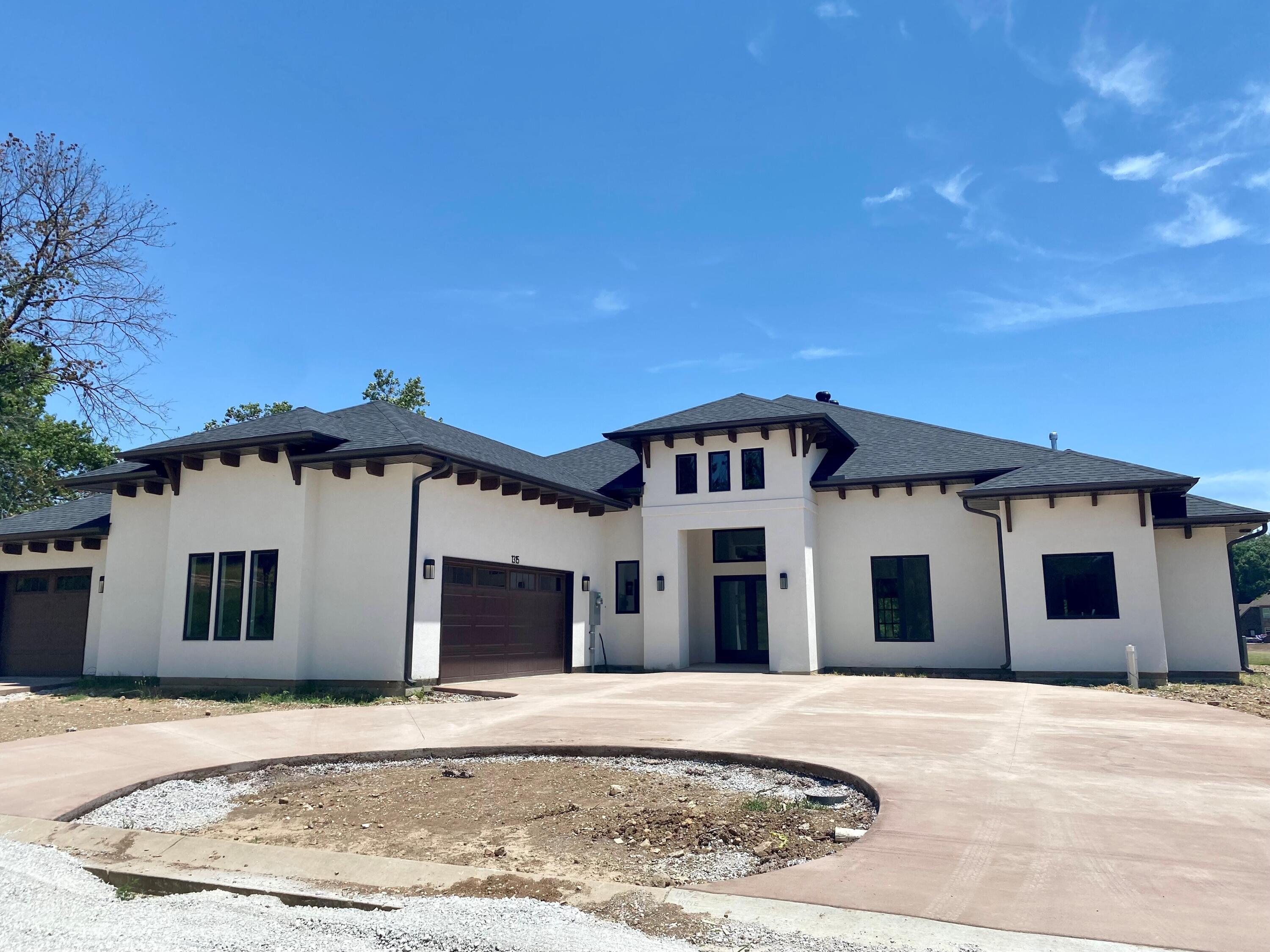 Stunning new construction in the desirable Waters Edge gated community. Lake front with tons of outdoor living space, including an outdoor wood-burning fireplace. High ceilings with breathtaking wood beams through the large open great room. Granite countertops, a wet bar, and an ample amount of windows to enjoy the lake setting. 4 bedrooms, 5 bathrooms, and a large 3-car garage.
