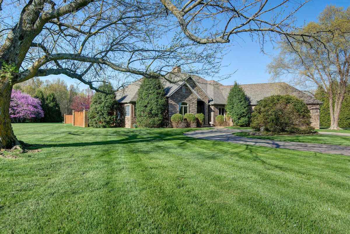 Welcome to 5150 W Skyler! This gorgeous all brick home sits on appx 4.5 acres with almost 3600sf and an extra 2-car garage. Pull into the circle drive and step through the grand entryway to this beautifully detailed home. A split bedroom plan with 3 bedrooms plus a large office space and 2.5 baths. A well appointed kitchen with gas cooktop with Tuscan brick surround, additional electric cooktop with grill, oversized sink, granite countertops, walk-in pantry, a bar area that is open to the dining area, plus a hearth space with gas fireplace. A total of 3 living areas, including the heated sunroom - all with fireplaces. Great daylight flows in with an abundance of windows and skylights. The primary bedroom ensuite includes 2 walk-in closets, large bath with jet tub and walk-in shower with multi-head sprays. Step out to the private side patio for a dip in the hot tub, or just enter the sunroom for that morning coffee overlooking the patio area and beautiful patio setting. The outdoor paradise offers a pool with a newer liner and radiant solar panels to heat the pool. Another fireplace on the expansive patio space for the full entertainment options, all within a fenced area for privacy and safety. Oversized laundry room includes a ton of cabinets, counter space and rods for those hang-dry clothes. Dual HVAC systems that are fairly new. So many extras - a storm hatch access in a closet floor, generator, huge mud room type space between the garage and house, which also provides easy access to the extra garage, and tons of cabinetry in the attached garage. Call for your showing today!