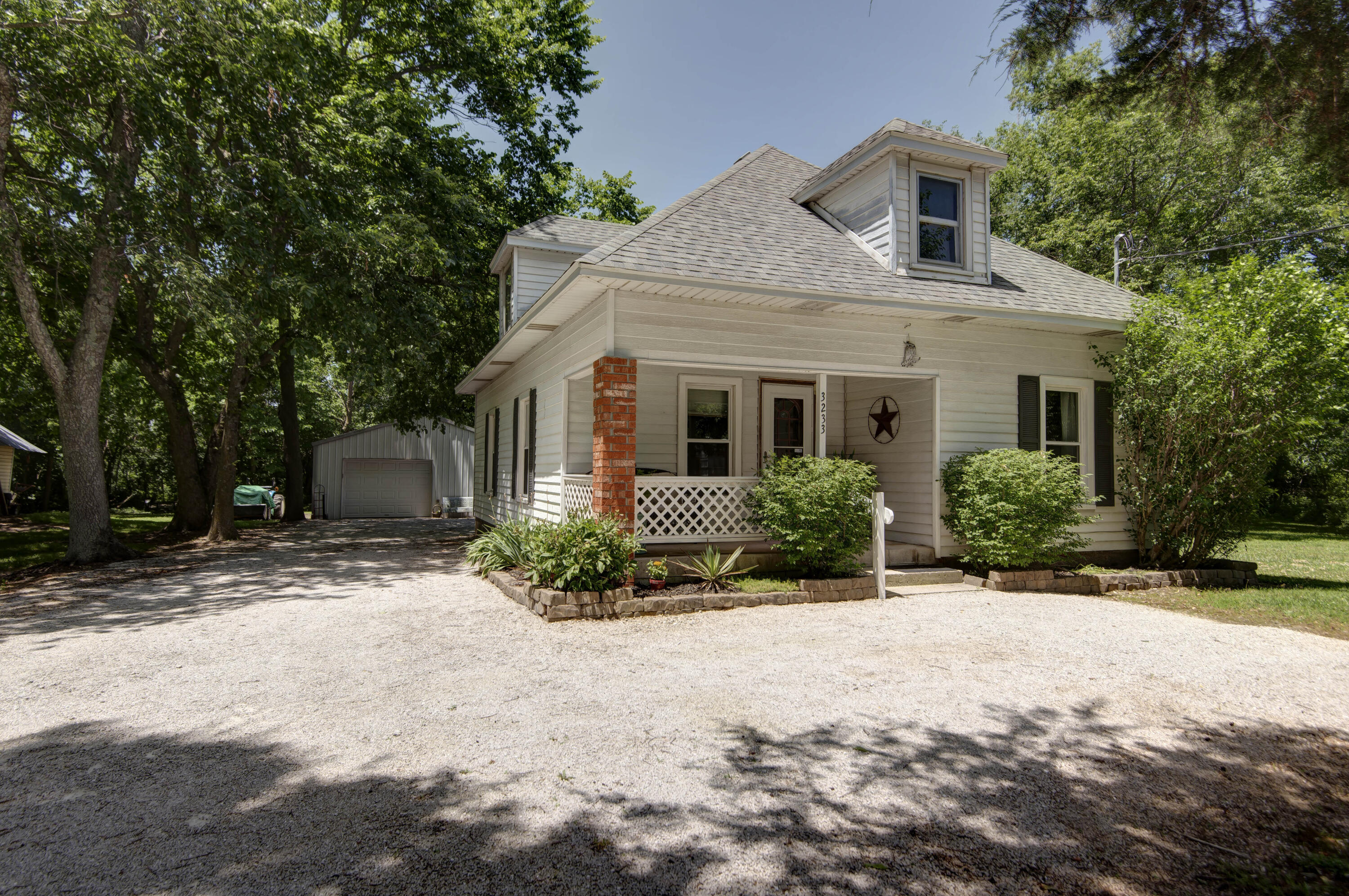 What a wonderful quiet county setting with easy access for this super sharp porch swing ready 2 bedroom 1 bath home with all the character you have ever dreamt of.  Many, many updates in the last 10 years including Lennox high efficiency central heat/air, electrical panel, roof, attic insulation, and much more.  Covered front porch as well as huge 16x13 covered rear deck overlooking beautiful yard and surrounding timber.   30x24 shop/garage with concrete floor and electric, storm cellar & 2 storage shed.    Hurry, you won't find a nicer setting.