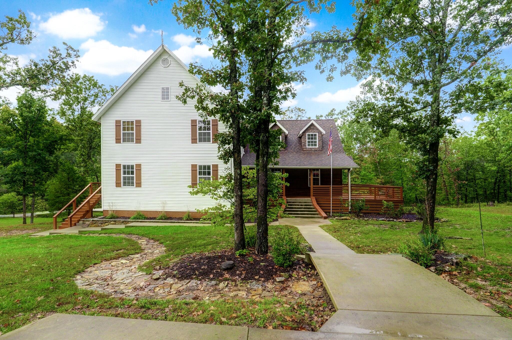 Country living is easy in this impressive, generously proportioned residence with beautiful, wooded views all on 57+ acres.  Lots of trails cut through the property for your own UTV or ATV riding. Lots of room for hunting or bring your animals with the 16-acre fenced lot, with a loafing shed. The open floor plan encompasses five spacious bedrooms with plenty of room for a family... three and half luxurious bathrooms, and a sleek and stylish kitchen that flows through to the dining room and living area with an inviting fireplace...The master bedroom, complete with walk-in closet and   ensuite bathroom with a jetted tub., Don't miss the covered porch for enjoying your morning, 2 fabulous decks for easy entertaining and enjoying the beautiful views...  This home is immaculate and Perfect for a family.  This home features a new roof, heat pump, well pressure tank, 75-gal water heater, April-Are steam humidifier added to central Air system and reverse osmosis rain soft water softener.   The detached/workshop garage is approximately 1200 square feet with room for 2 cars.  Don't miss this fabulous home and acreage just a short drive from Springfield.