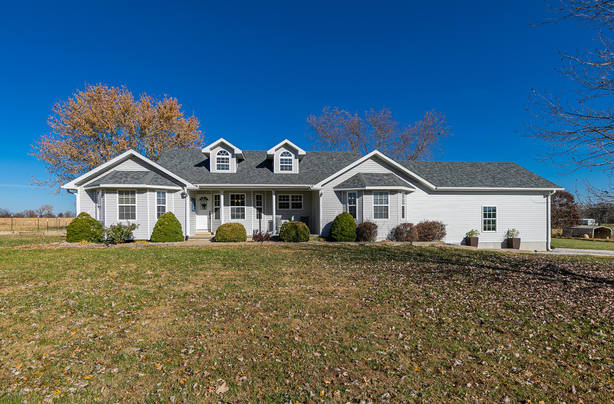 A midwest dream!  Peaceful, spacious, and gorgeous views in every direction.  This 3000+ sq ft home sits on 3.5 acres, with space for everyone, indoors or outdoors. When the current owners first purchased, they said they ''felt like they were on vacation every day.''  This home easily has 4 bedrooms, plus a large bonus room upstairs with its own private bathroom access (so could be 5 bedrooms depending how you want to use the space).  A bright kitchen and eat-in dining area, plus two additional living areas make this home comfortable and easy to live in. Multiple flex spaces allow ample living arrangement options, everyone can find their own nook to spread out in.  Inside the home new carpet has been installed along with new luxury vinyl tile, hardwood floors have recently been refinished, along with fresh paint. HVAC is dual fuel and newer as well. Owner worked from home and streamed video calls so internet access is very good.  Outside you'll find the 20' x 38' detached garage with concrete floors and electric.  Average utility was just $134/month last year.  Out back, enjoy the patio, firepit, privacy, and wide open spaces.  Located just around the corner from everyone's favorite fishing hole on Pomme De Terre River, the location is fabulous, while being just 4 miles from Citizens Memorial Hospital.  This truly is a wonderful property, a great opportunity for the next owner.