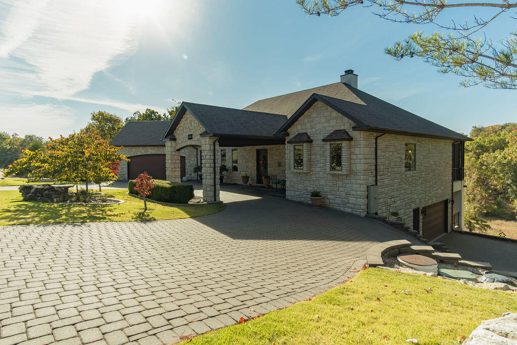 Showcase, Original Owner, Custom Golf Front Home.  4 Bedroom, 4 Bathroom, 4 Car Garage, Workshop, Wet Bar, Fireplace, Engineered Hickory Hardwood Floors, Granite, Professional Grade Appliances, 36' Doors in all rooms, 5 French Doors (Anderson Doors & Windows / High E), Jetted Tubs, Sand Pavers, Safe Room / Rec Room, Handicap Accessible, 2 Covered Decks on Back of Home and Porte-Cochere on Front, Professionally Landscaped, Sprinkler Systems in Front and Rear, Gated Community with Pool, Golf, Tennis Courts.  Close to Shopping, Hospitals, Shows, Lakes - Table Rock, Taneycomo, Bull Shoals.  Must See!  Won't Last.  Office/Study could easily be a Bedroom or Formal Dining, Over 7,000 sq ft under roof!
