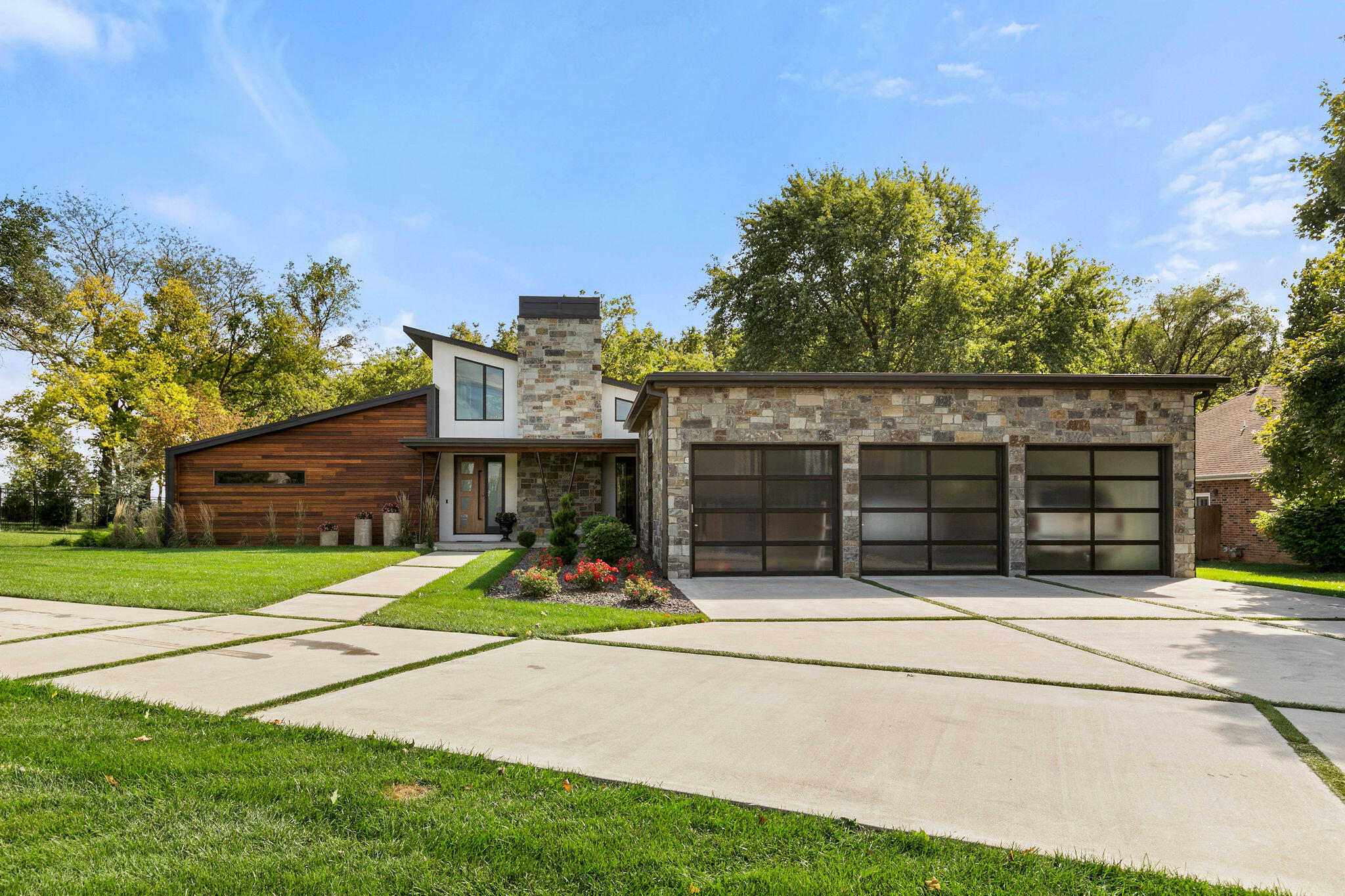 Say hello to this gorgeous luxury modern home! This custom picturesque home sits on a little over half an acre and has much to offer. When walking into the home you are immediately greeted with an abundance of natural light, cool tones, maple hardwood floors, and an open concept. The living room offers a gas fireplace, lots of room for entertaining, and high ceilings. The kitchen is a sight to see and comes equipped with professional grade stainless steel appliances, granite countertops with a natural feel, custom cabinets, and a large island.  Right off the kitchen you will find the mud room/laundry room that has lots of storage and a sink. Down the hall you don't want to miss the beautiful master bedroom and bathroom. The bedroom offers custom shelving inserts, a wood burning fireplace with a gas log insert installed, lots of natural light, and a cozy patio. The bathroom is a sight to see and has a soaking tub, custom his and hers vanities, large walk in closets, and a walk in shower that offers dual shower heads and temperature controlled tile on the floor. This home also offers a one bedroom junior suite as well as an additional bedroom and a shared bathroom for both rooms. Once outside you can't miss the covered patio that includes a built in gas firepit. In the backyard you will also find the newly remodeled guest house. The guest house offers a full kitchen, two bedrooms, and one bathroom. Don't miss your chance at Luxury Living - call today to schedule a showing!