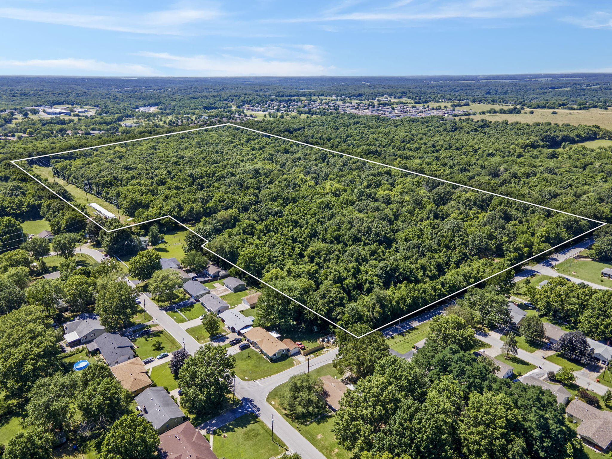 57.19 +/- acres of development land in Springfield! Single family zoning located close to Dickerson Park Zoo, Ozark Empire Fairgrounds, and near Hillcrest Highschool. Highly sought after Truman Elementary. Utilities available. Quick access to I-44.