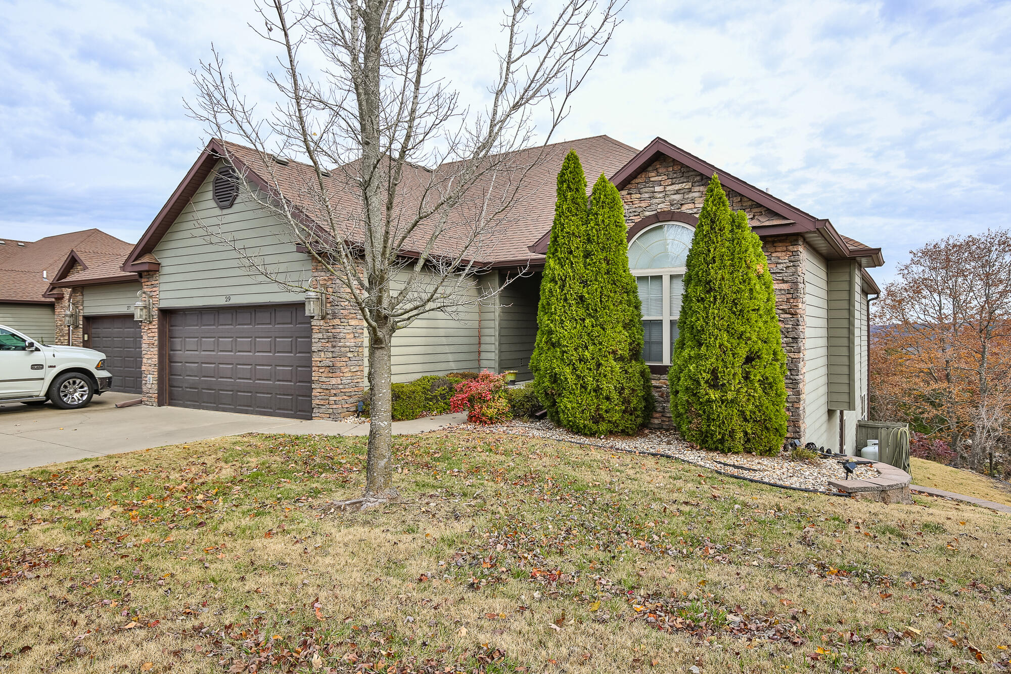 Are you looking for the perfect home in the Branson area that can be used as a vacation rental? Look no further!!!! This is a must see 5 bed, 3 bath, 2 car garage patio home located in Stonebridge Village! This is a luxury gated community just minutes away from Silver Dollar City, Table Rock Lake, and all of the amenities that Branson has to offer. Properties like this don't come available very often. The neighborhood hosts one of the most pristine public golf courses in Southwest Missouri (Ledgestone Country Club)! This property is literally in the perfect location whether you are wanting to make it your primary residence, your 2nd home, or a vacation rental. At the end of a dead end street with views that are incredible surrounded by trees and wildlife. This unit has a neighbor that is a full time resident, NOT a vacation rental. There are two living areas that offer plenty of space for everyone to spread out. Both levels feature screened in porches where you can enjoy the morning coffee or watch the wildlife and gaze at the stars. If you are more of an indoors person, this villa has a beautiful built-in fireplace that is surrounded by floor to ceiling stone. You will love the soaring high ceilings that make this property feel so spacious. This property is fully furnished and turn-key, just bring your bags and enjoy. Stonebridge Village has so much to offer, from the amazing restaurant in the Clubhouse, the numerous outdoor pools, a tennis court, a workout facility, nature walking trails, several playgrounds for the kids, a catch and release man-made lake, and gated security for the safety of your loved ones. Oh yeah, with the association dues, all exterior maintenance is taken care of including landscaping and lawn work. Current owners will provide a new professional paint job for the entire property with an acceptable offer. Once again, it also comes with ALL THE FURNISHINGS!!! Don't miss out on this one! No showings without proof of funds or prequalification.