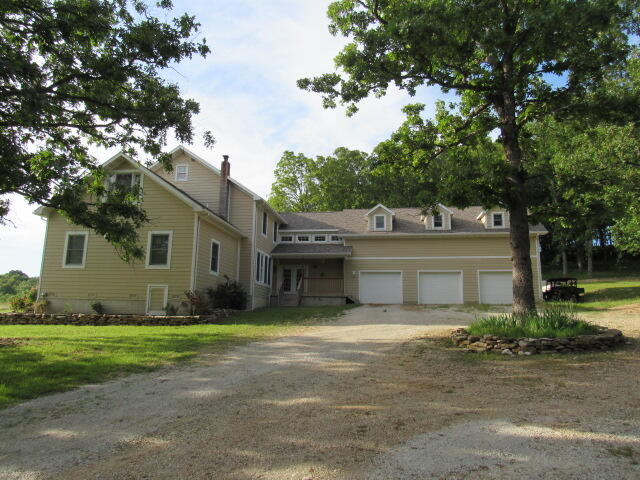 A one-of-a-kind large home with breathtaking views! Along with 22 acres the house set's back into the property with a long private driveway This 5600 sq. ft. home offers 5 bedrooms, 3 1/2 bathrooms, an office, 19x14 kid's playroom, a 20x26 Master Bedroom/Bathroom on the main level and a 19x41 large open room over the 3 car garage. The kitchen is large with custom cabinets, prep sink and built -in gas griddle. A second bedroom on the upper level has a private bath , the main level utility room has hookups for two sets of washers and dryers, there are three heating units and a free standing fireplace.  The 22 acres is over half in good pasture and hay ground and is fenced with a pond. NO RESTRICTIONS!