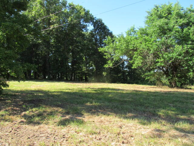 Brush Hog almost completed and reafy to go! Hilltop property overlooking the countryside with 98 acres. There are 5 bedroom's (two non-conforming) with 3 being on the main level. Two finished living areas with additional space in the basement that has been framed and has partial sheetrock. Very nice kitchen cabinets, breakfast nook, formal dining room with a bay window with sitting area and living room with wood burning fireplace. Upstairs there are two rooms, common play area, bathroom, office and floored storage in both eaves and a single storage room. The property consists of a shop building with a roll up garage door, entry door, a sliding door, bathroom, window air and an outdoor wood furnace for heat.  There are also a Quonset Barn with an attached corral. There is 1 pond and 3 cattle waterers. This property has Highway 5 frontage and a long driveway back to the house and can't be seen from the road. The property is located right outside of the city limits and would make a great subdivision.